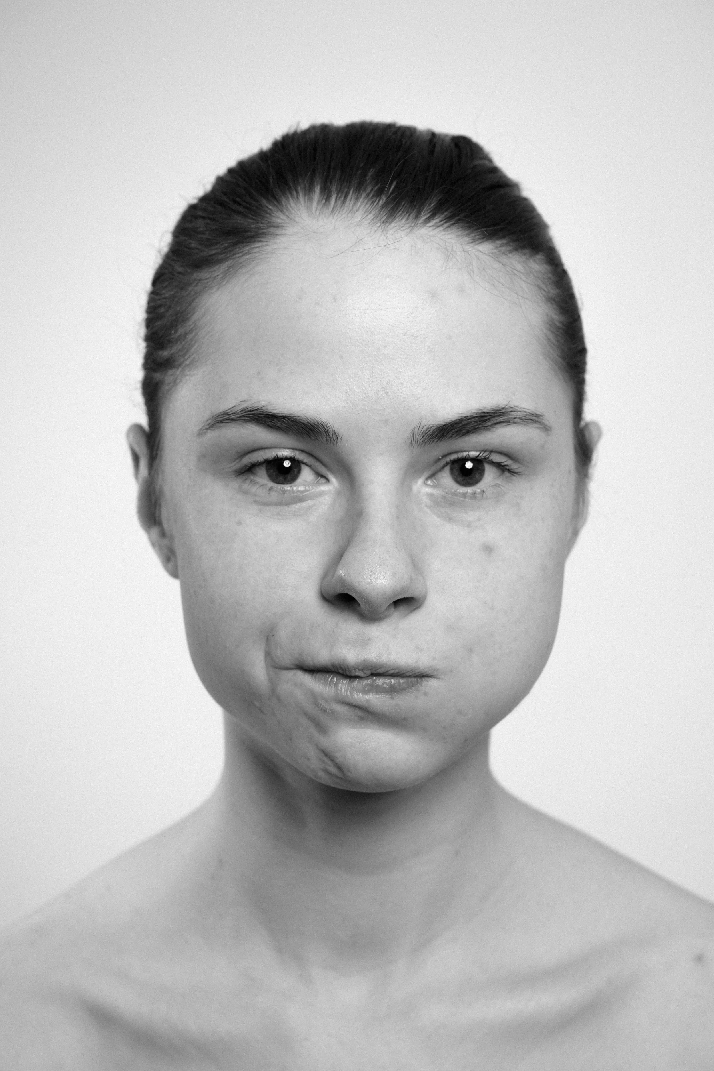 Studio portrait of a young woman in black and white.