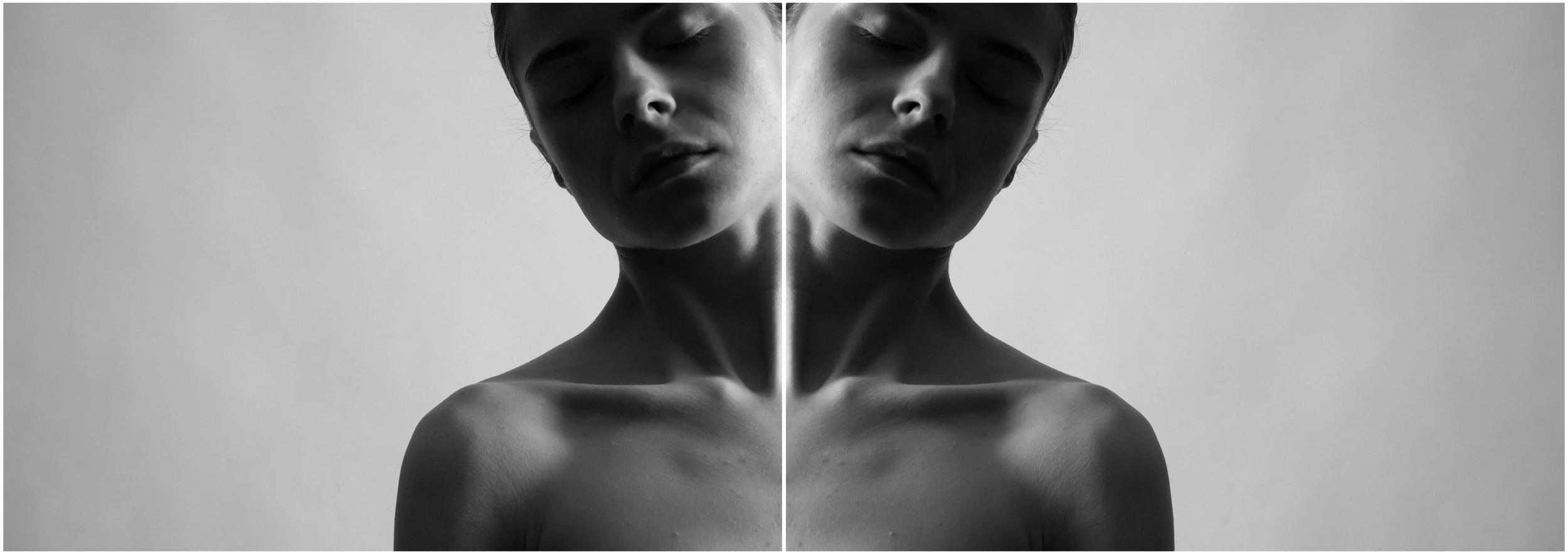 A black and white mirror-reflection photographic portrait of a young woman. A close-up. Her eyes are closed. Very strong shadows and contrasts.