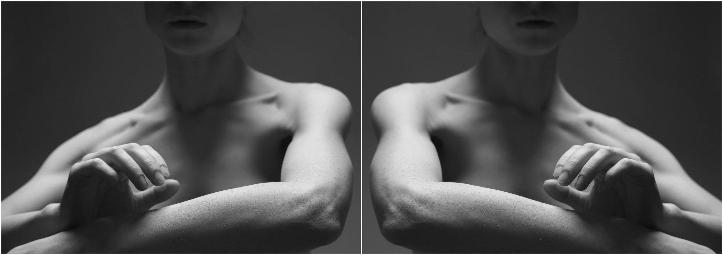 A black and white mirror-reflection photographic portrait of a young woman. A close-up. The arms reach and cross in front of the body. Very strong shadows and contrasts.
