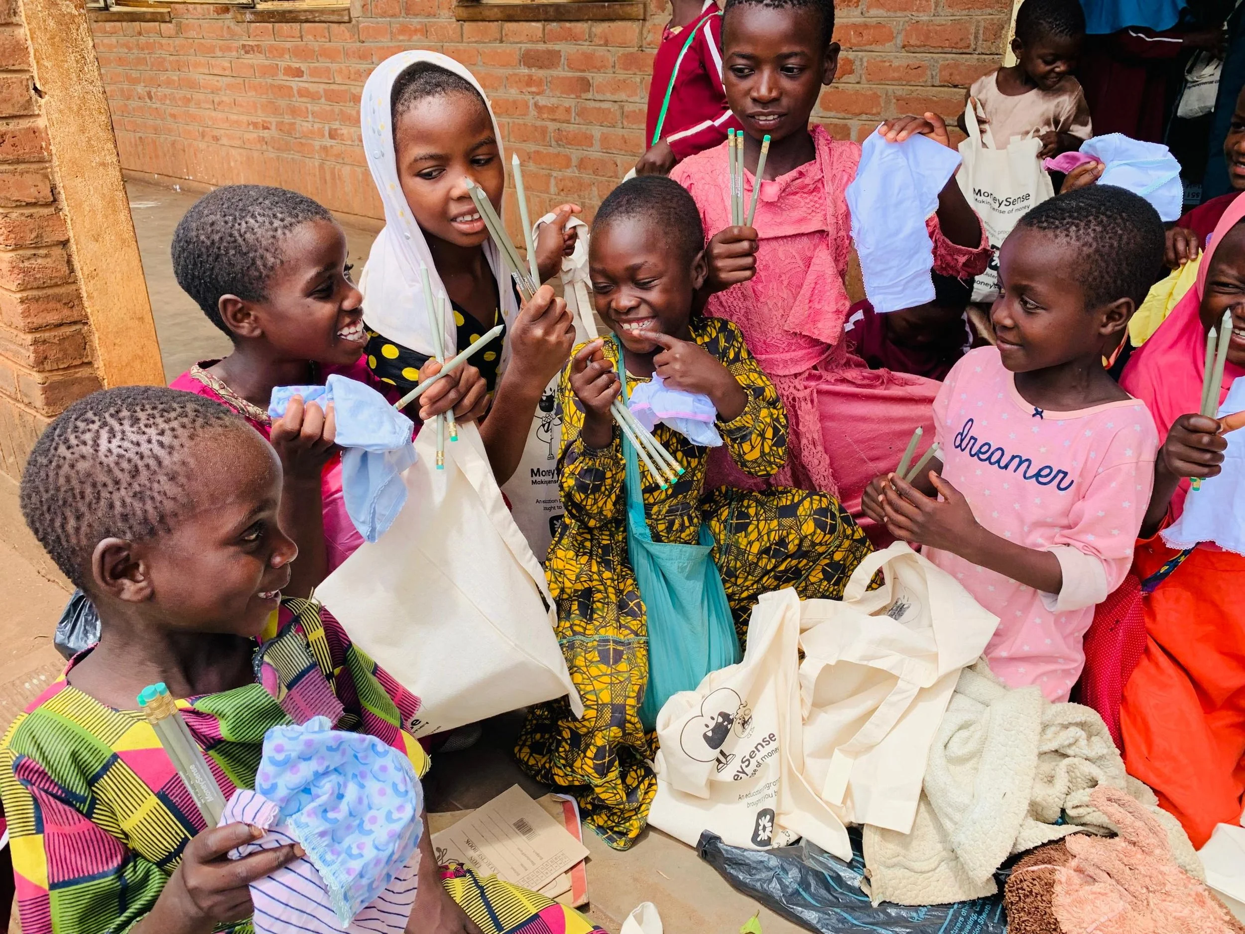 Girls recieving totes, stationery and knickers as part of our largest shipment to date - 70,000 items!