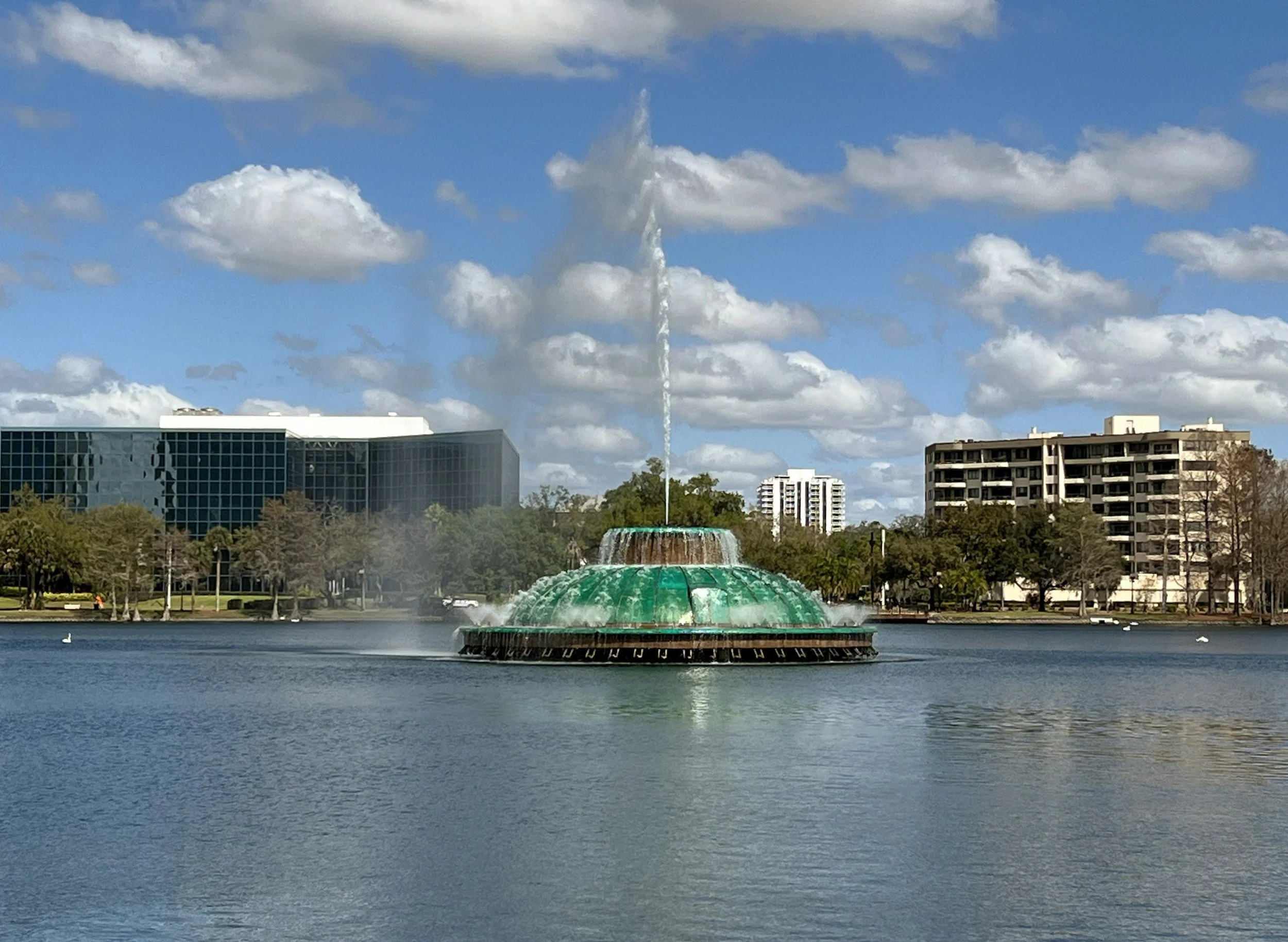 Lake Eola fountain in downtown Orlando Florida with city skyline and lake views