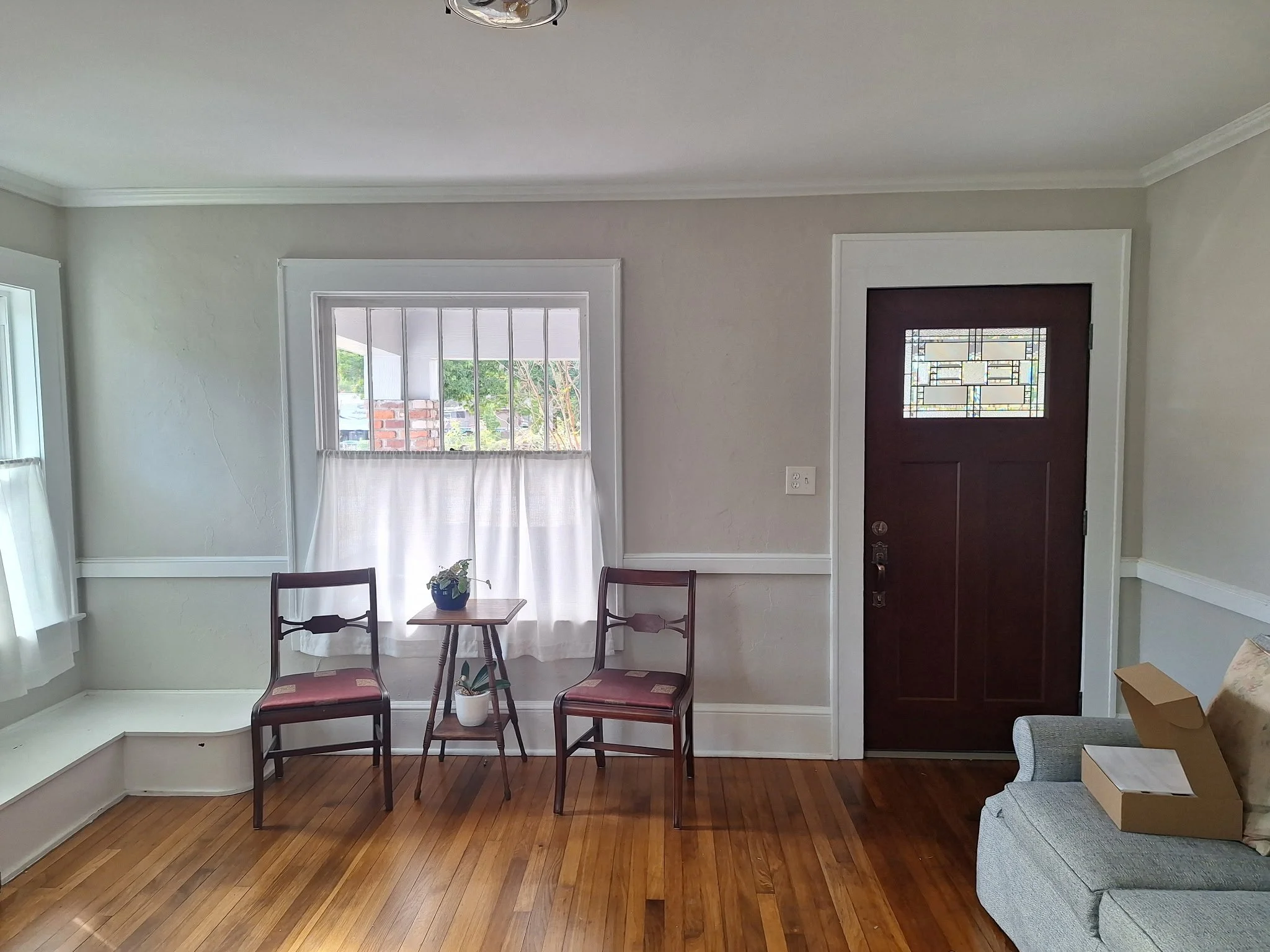 Living room interior painting in East Colonial Orlando with neutral walls and trim