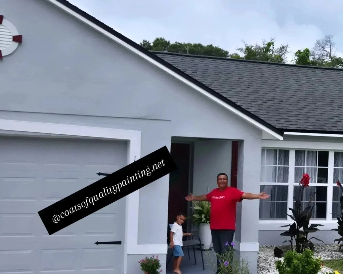 Deltona FL exterior house painting project completed by Coats of Quality Painting father and son team standing in front of freshly painted modern white Florida home with gray accents and landscaped front yard.