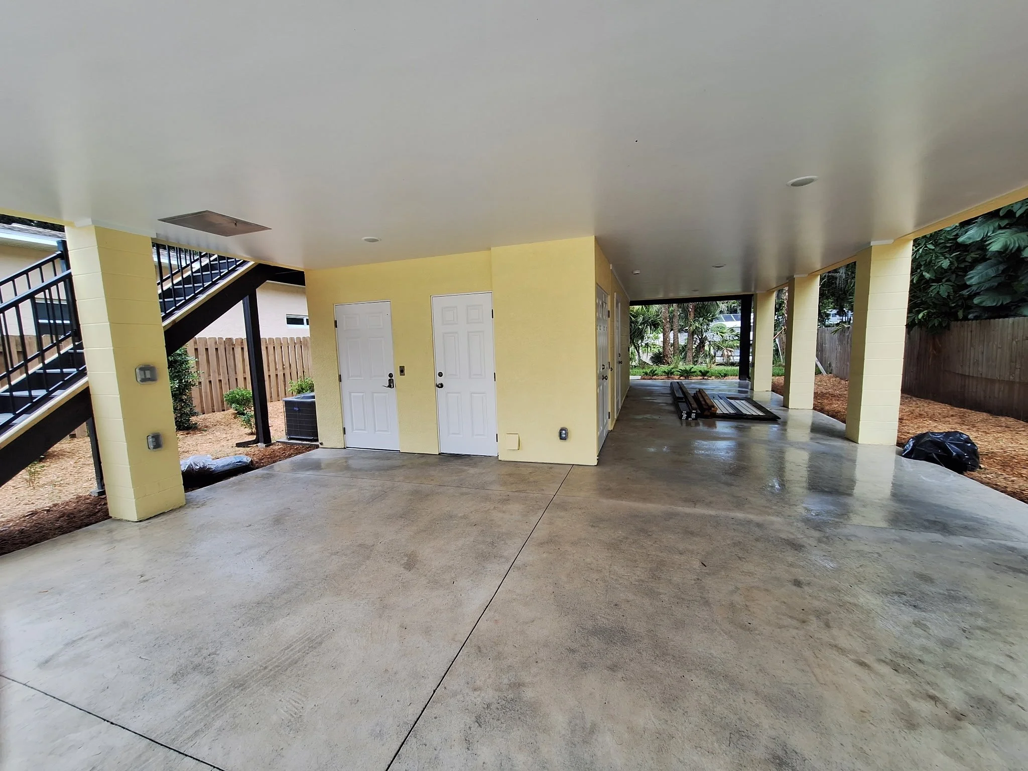 The under-home area was painted to feel open, clean, and functional. Bright finishes help reflect light while standing up to moisture common in canal-side properties.