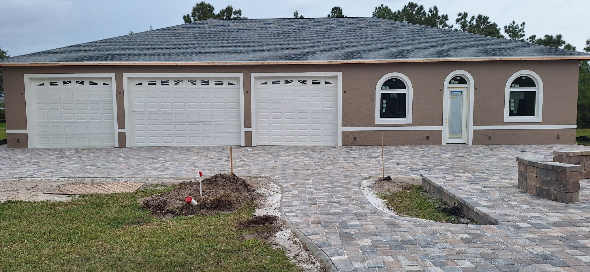Freshly painted stucco exterior home in Port Orange Florida with white trim and arched windows
