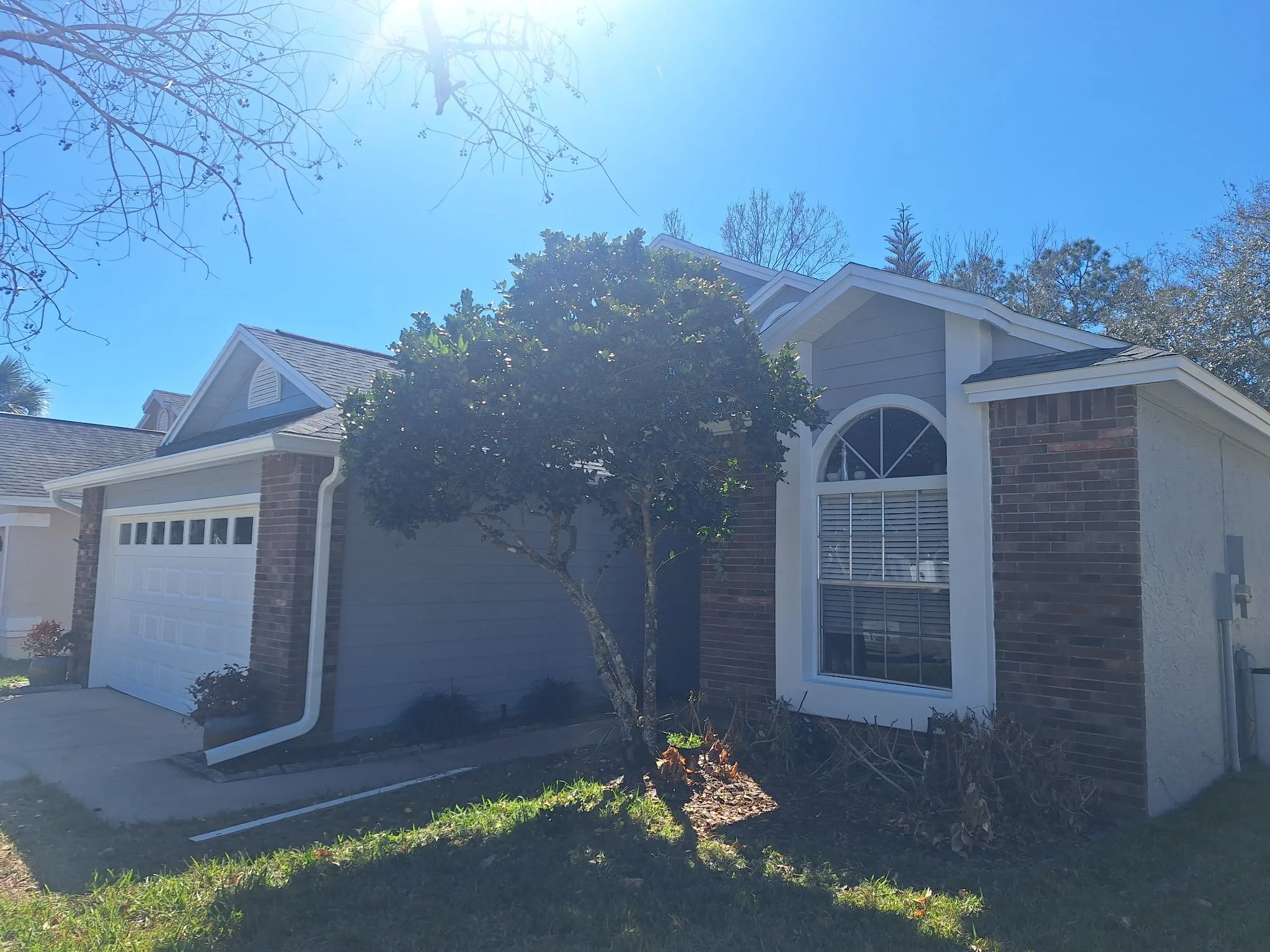 Freshly painted gray exterior home in Oviedo FL with white trim and modern curb appeal