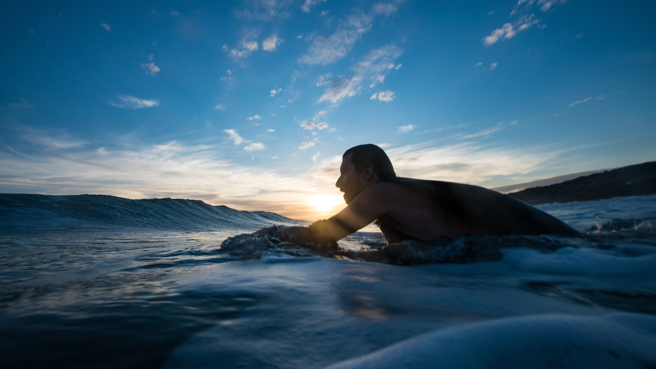 Surfer navigating the sea, illustrating freedom and security through income protection insurance coverage