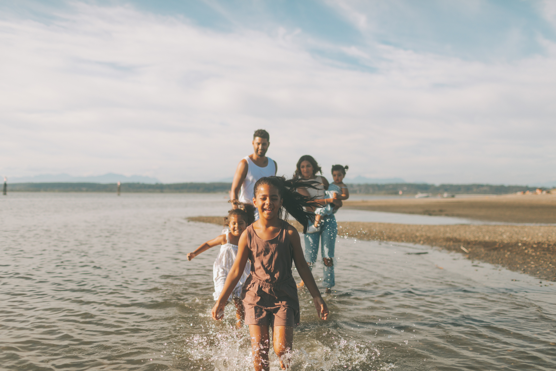 Happy family spending quality by the beach