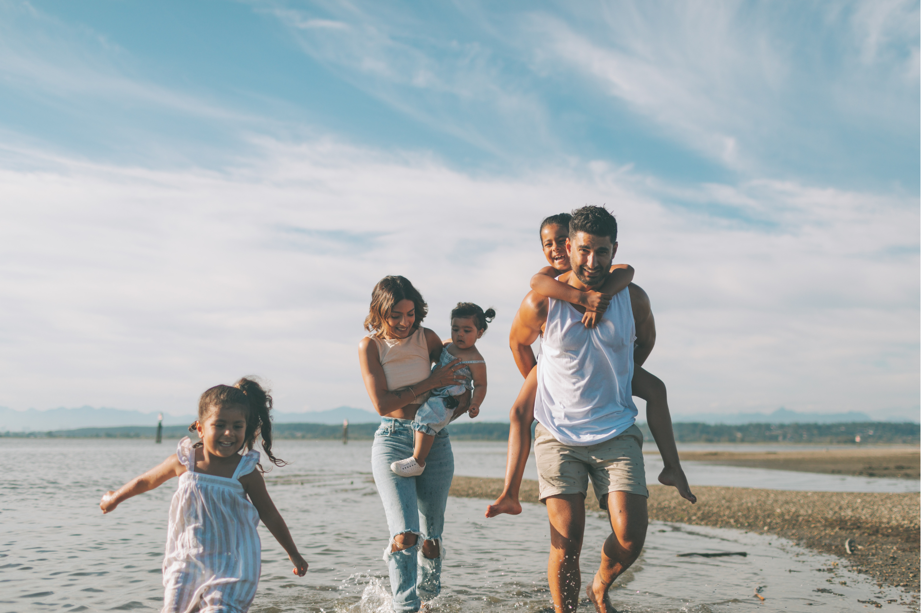 Parents and kids enjoying a sunny day by the sea