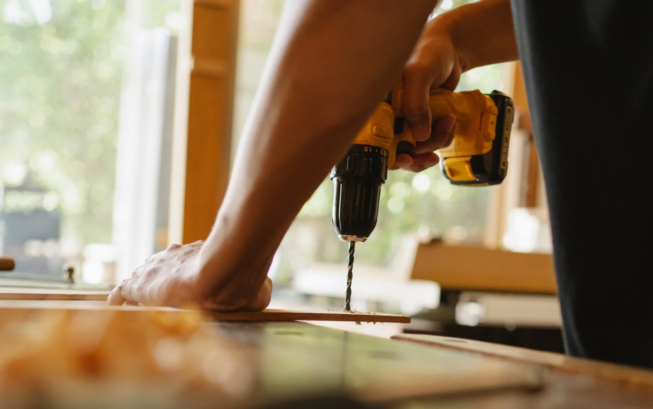 Close-up of person operating a drill safely