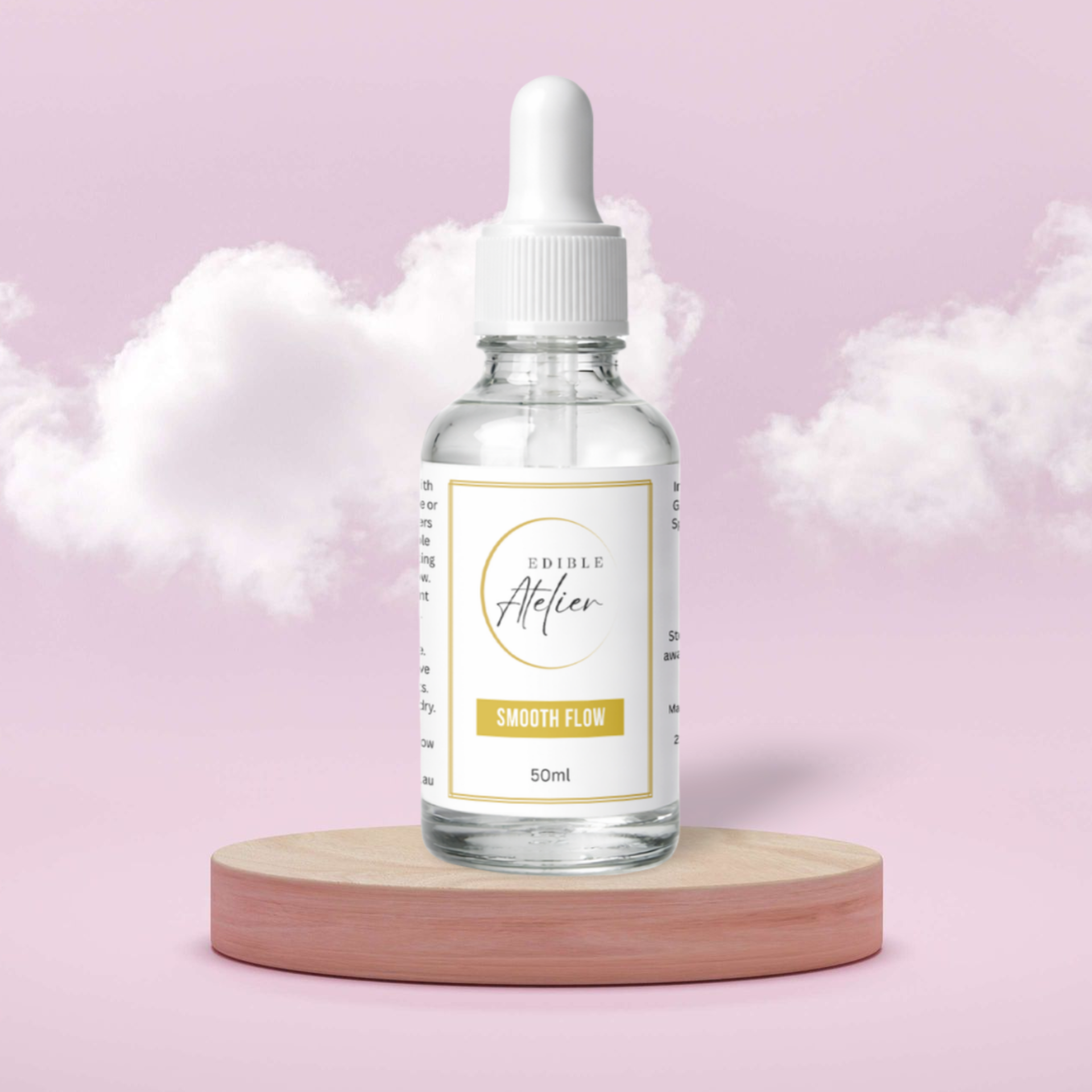 A 50ml clear glass bottle with a white dropper cap and a white label reading 'EDIBLE Atelier', 'SMOOTH FLOW', on a wooden pedestal against a pink background with white clouds.