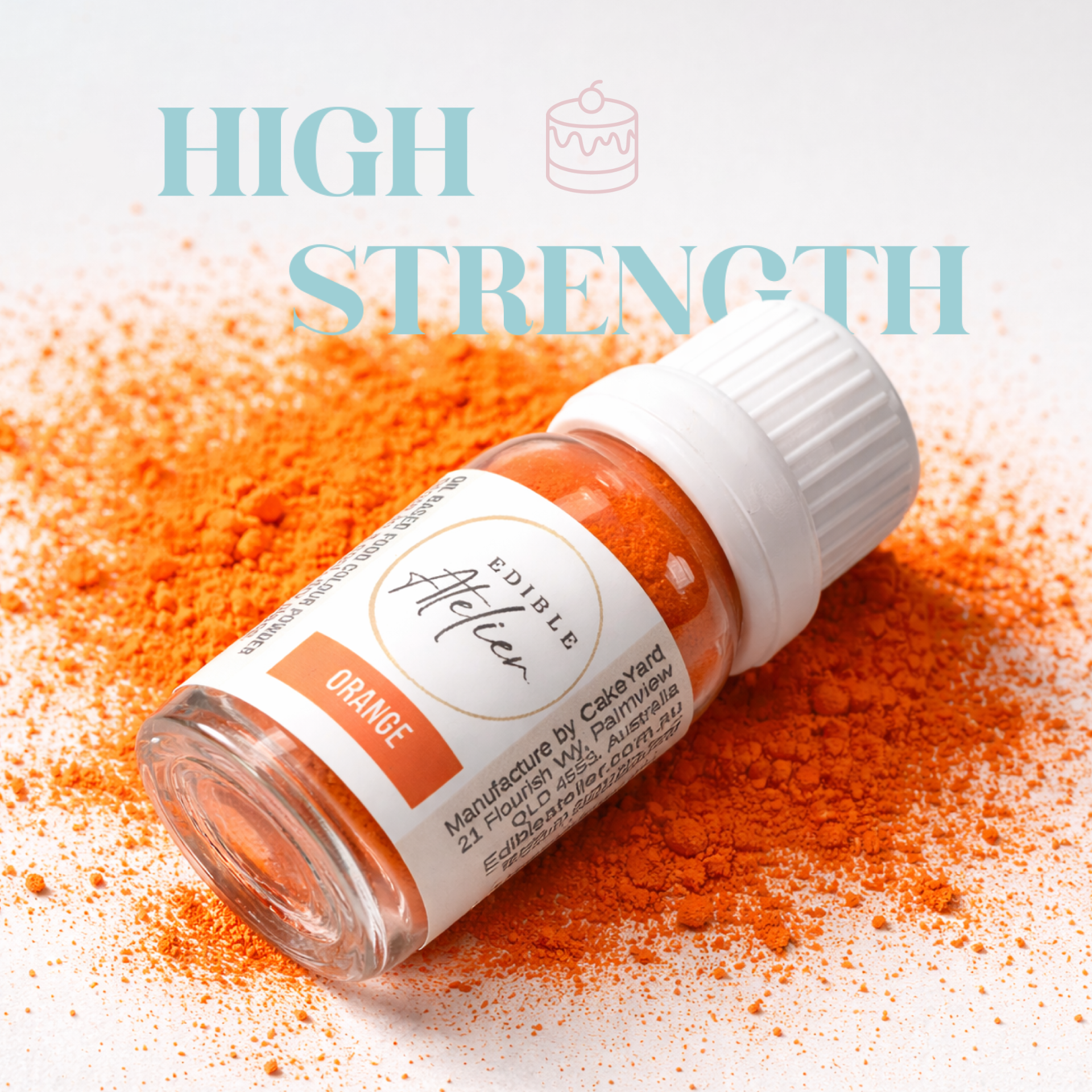 A bottle of orange edible pigment lying on orange pigment powder with text 'High Strength' and an icon of a cake on the image.