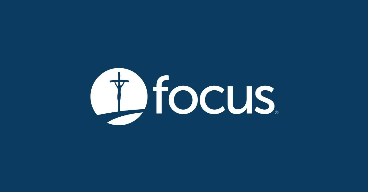 Focus logo with an icon of Jesus on the cross inside a circle, on a dark blue background.