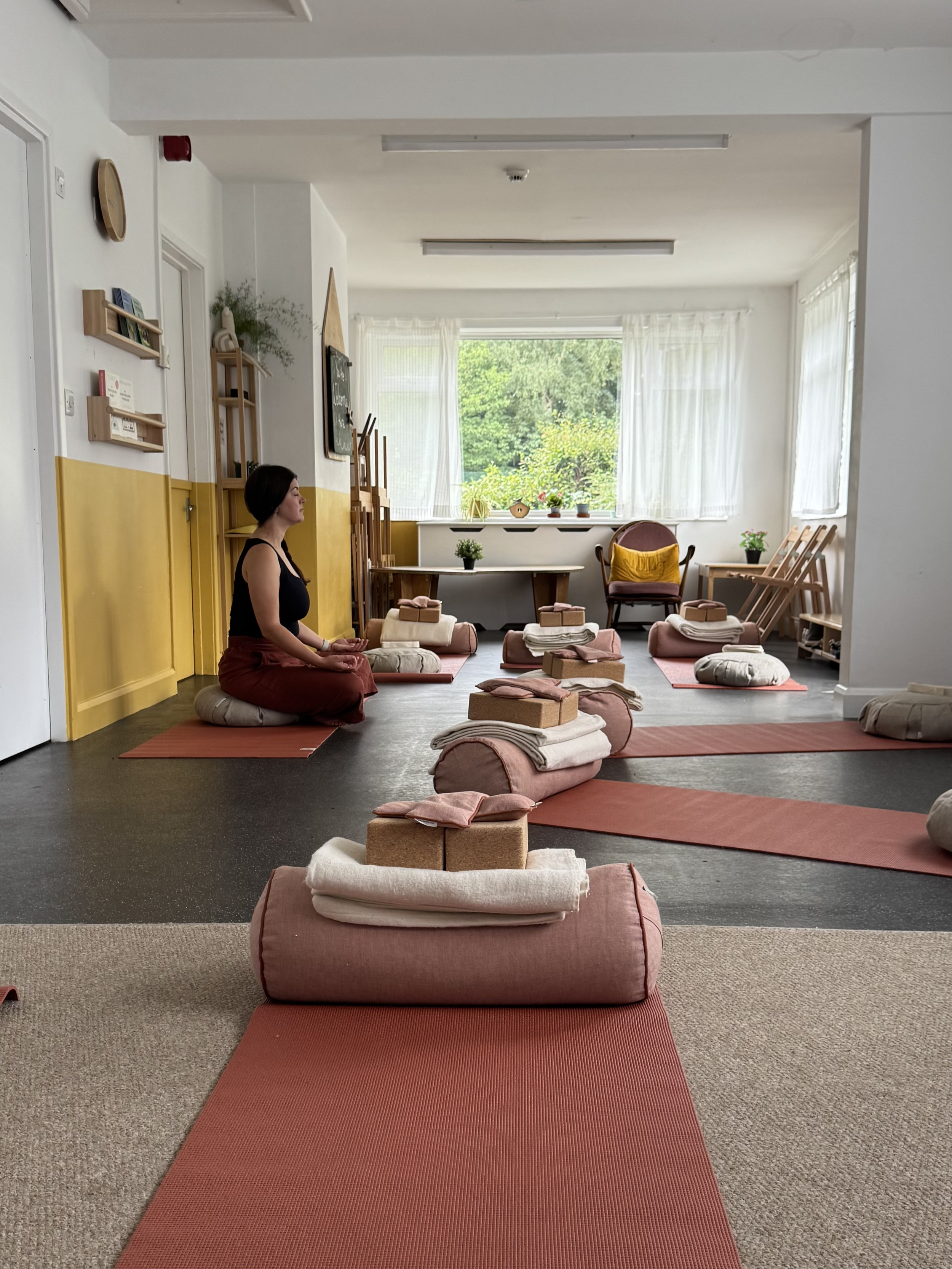 Yoga room with mats and yoga teacher