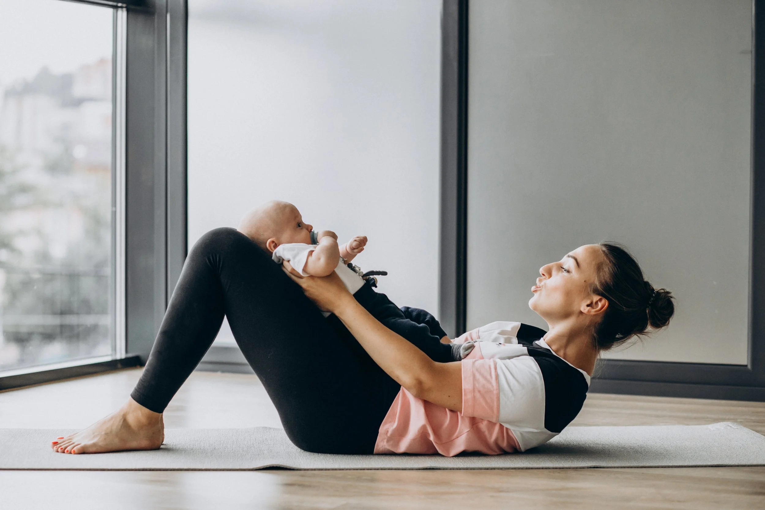 woman with baby boy practices yoga