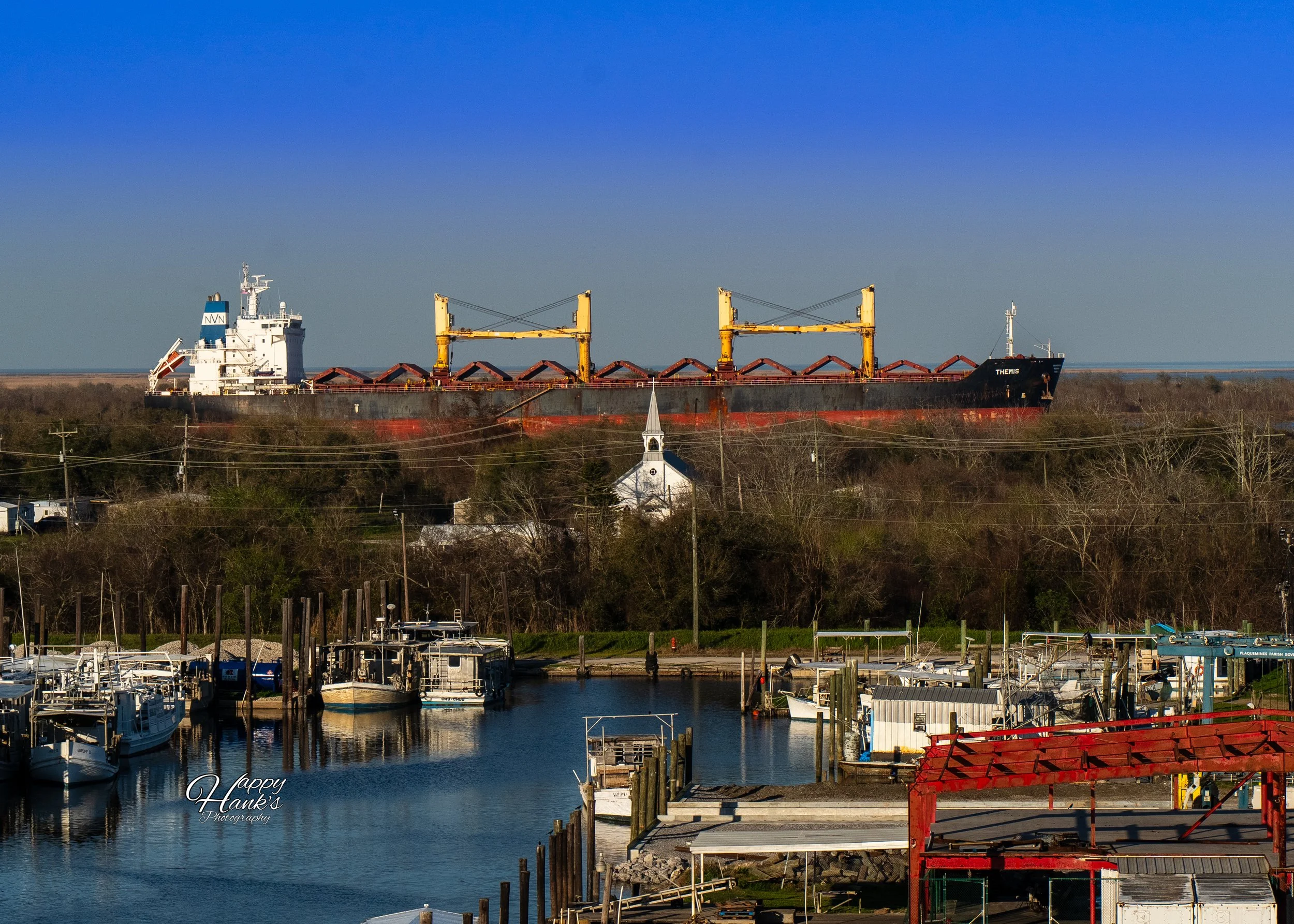 CARGO SHIP ON RIVER BEHIND CHURCHHOUSE