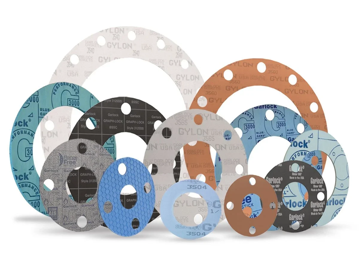 Collection of various circular gasket seals in different sizes and colors, including blue, gray, black, white, and brown, some with printed text and patterns.