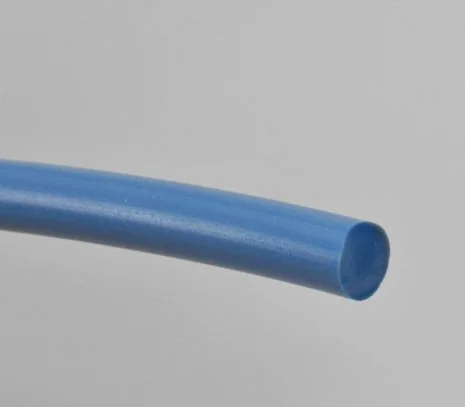 Close-up of a blue plastic tube on a gray background