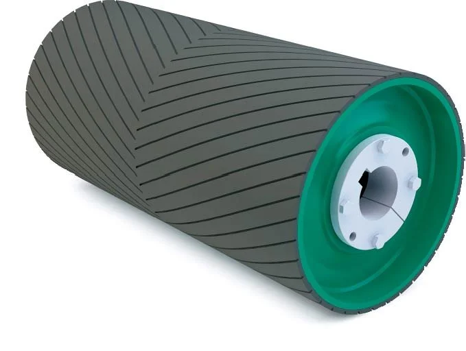 Rubber conveyor belt pulley with green casing and diagonal grooves.