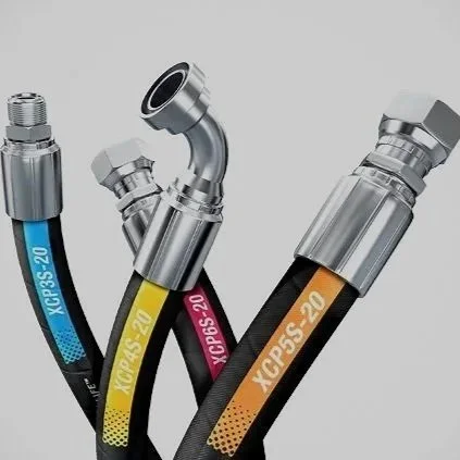 Collection of hydraulic or pneumatic hoses with metal fittings, labeled XCP45-20 and XCPS-20, in black, blue, pink, and orange colors.
