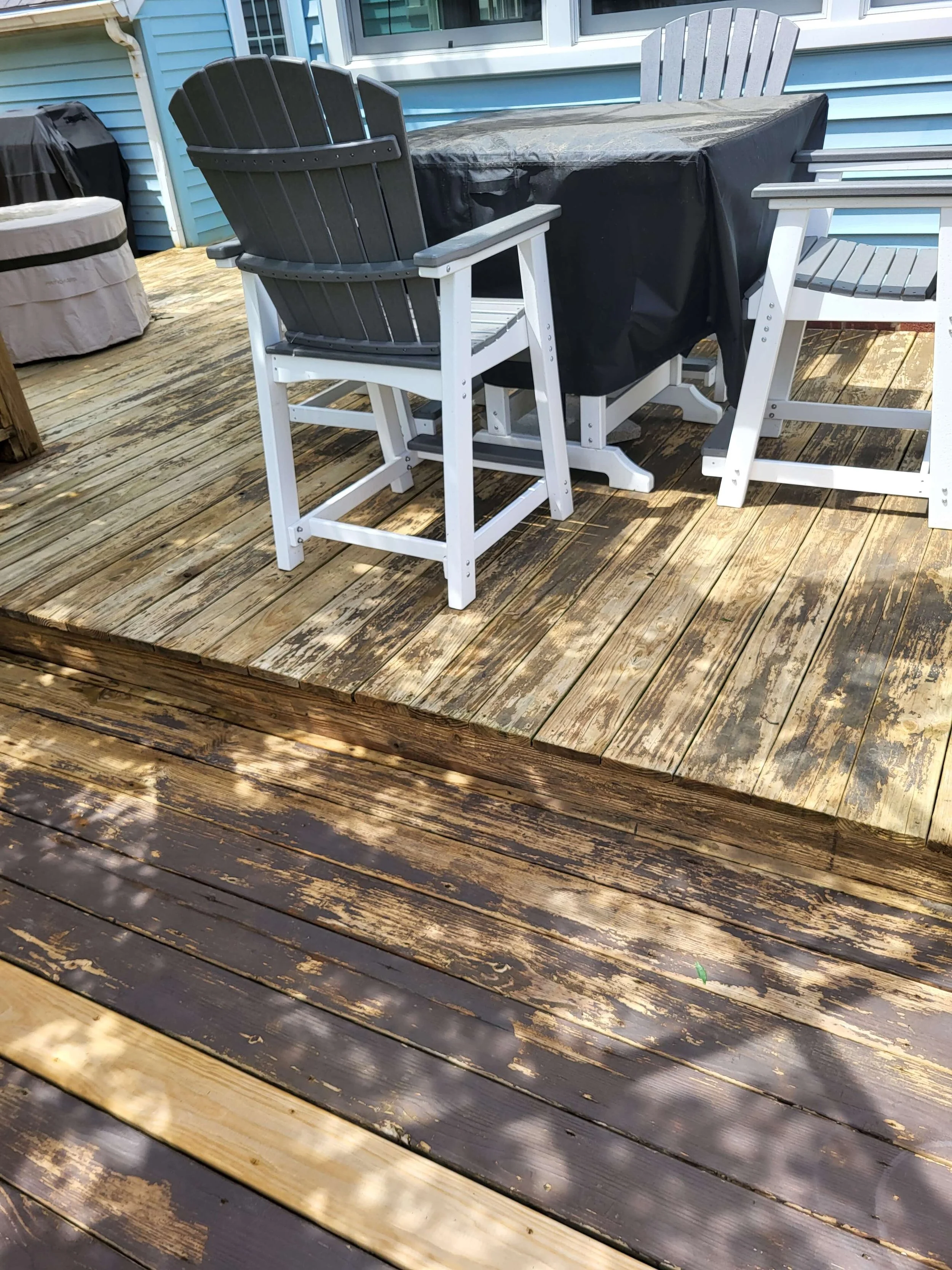 Weathered and peeling wood deck surface during pressure washing and restoration services in Hudson Ohio.