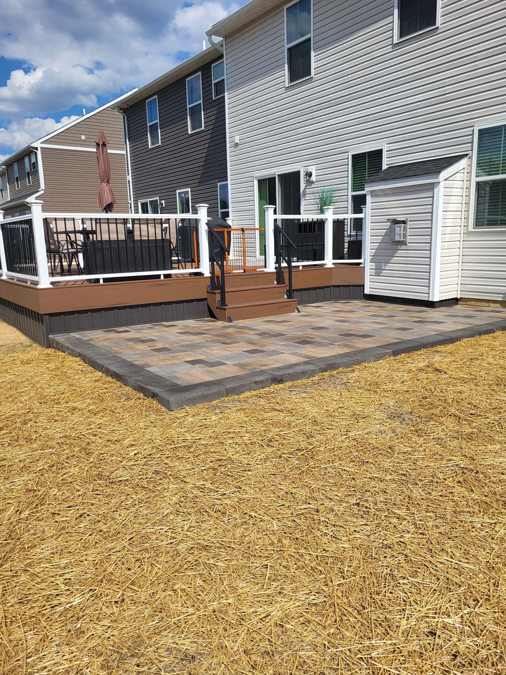 Finished composite deck with vinyl railing and black spindles in Northeast Ohio backyard