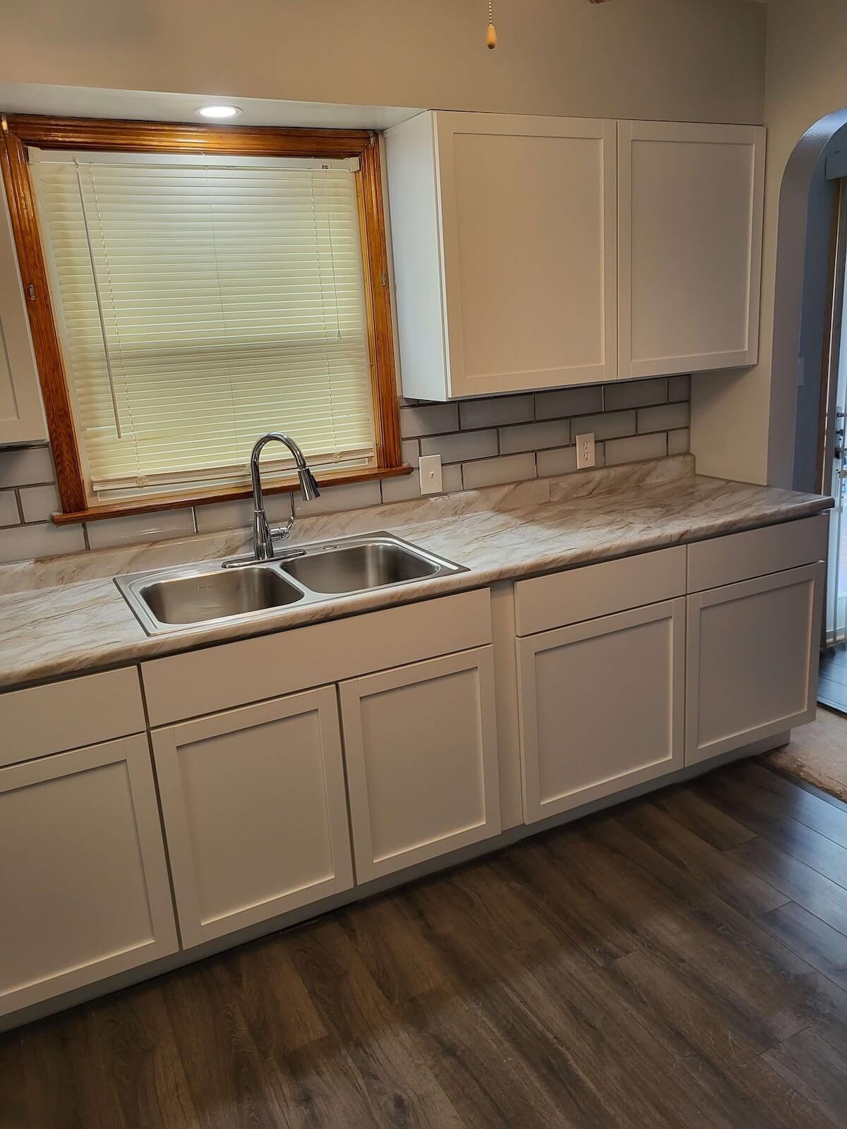 DLR Construction Cleveland kitchen renovation project featuring modern cabinets and custom white subway tile backsplash work.