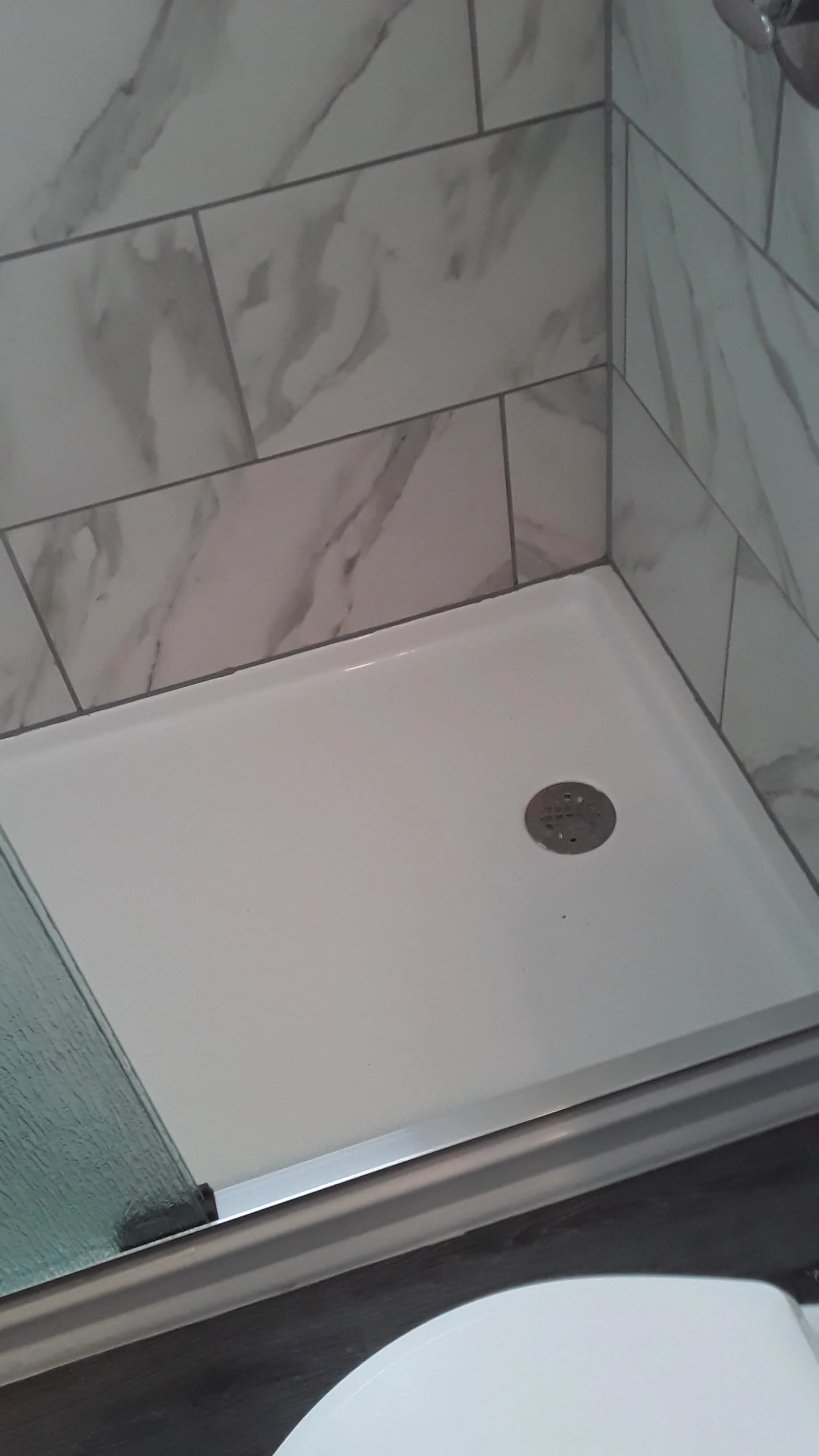 Custom tile shower pan and drain installation for walk-in shower Renovation in Akron.