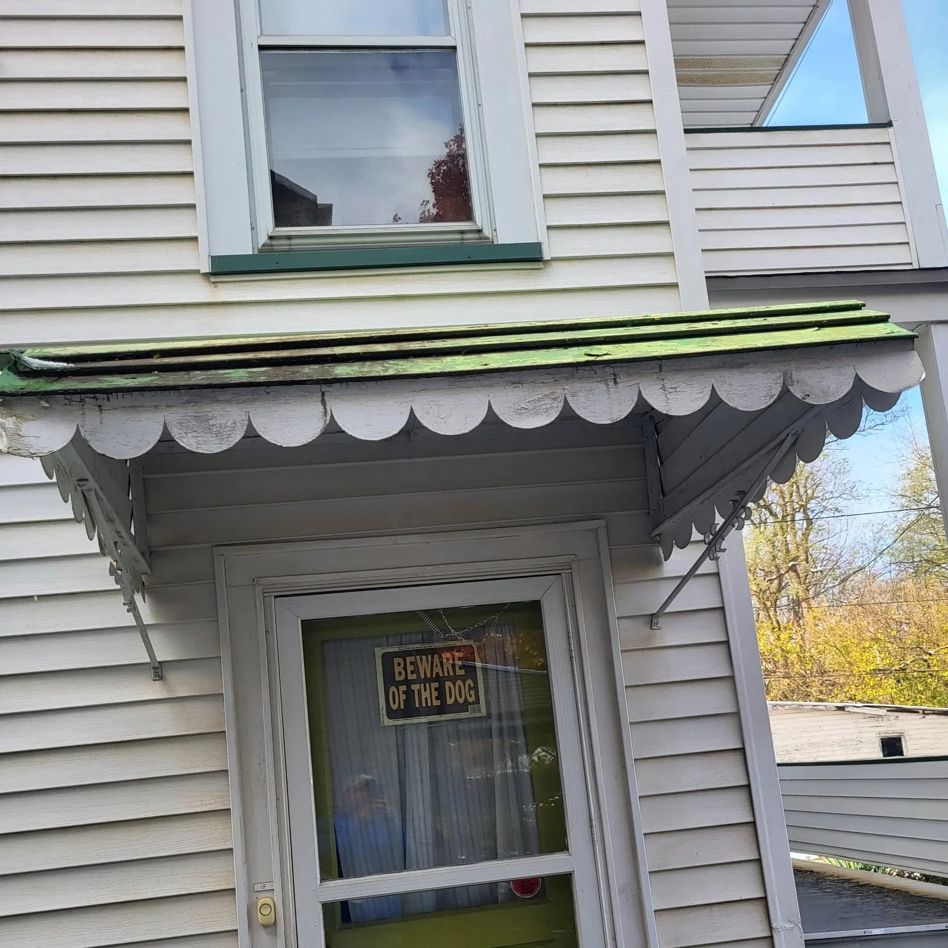 Close-Up of Damaged Metal Awning Showing Wear and Color Fading