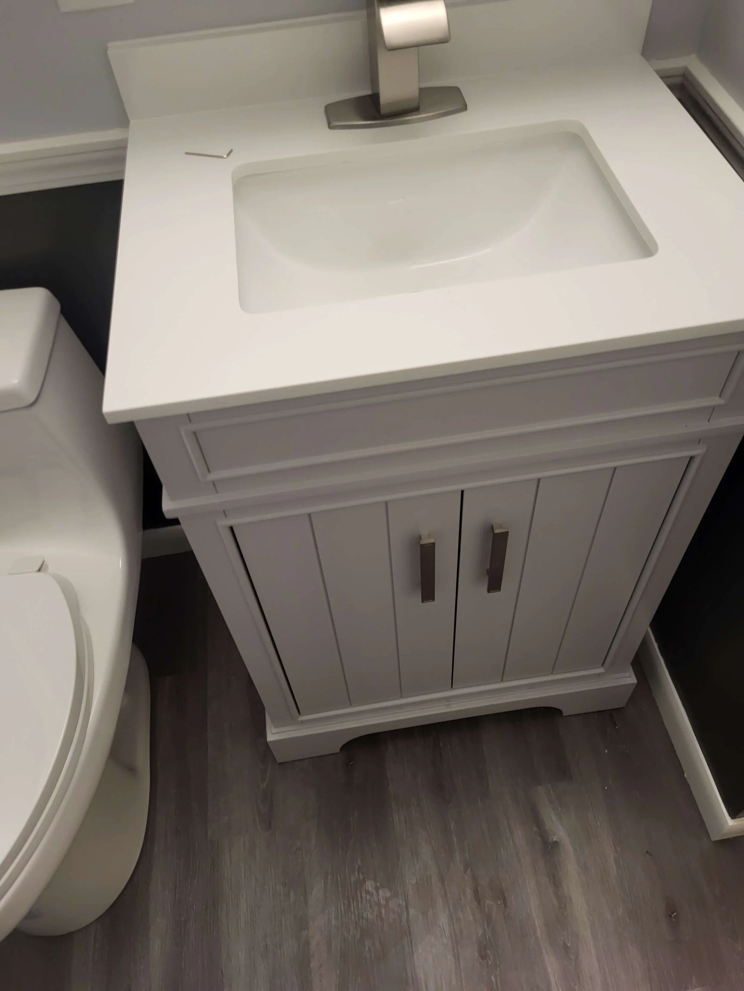 New Vanity, Sink Fixtures, Toilet, and Flooring Installation