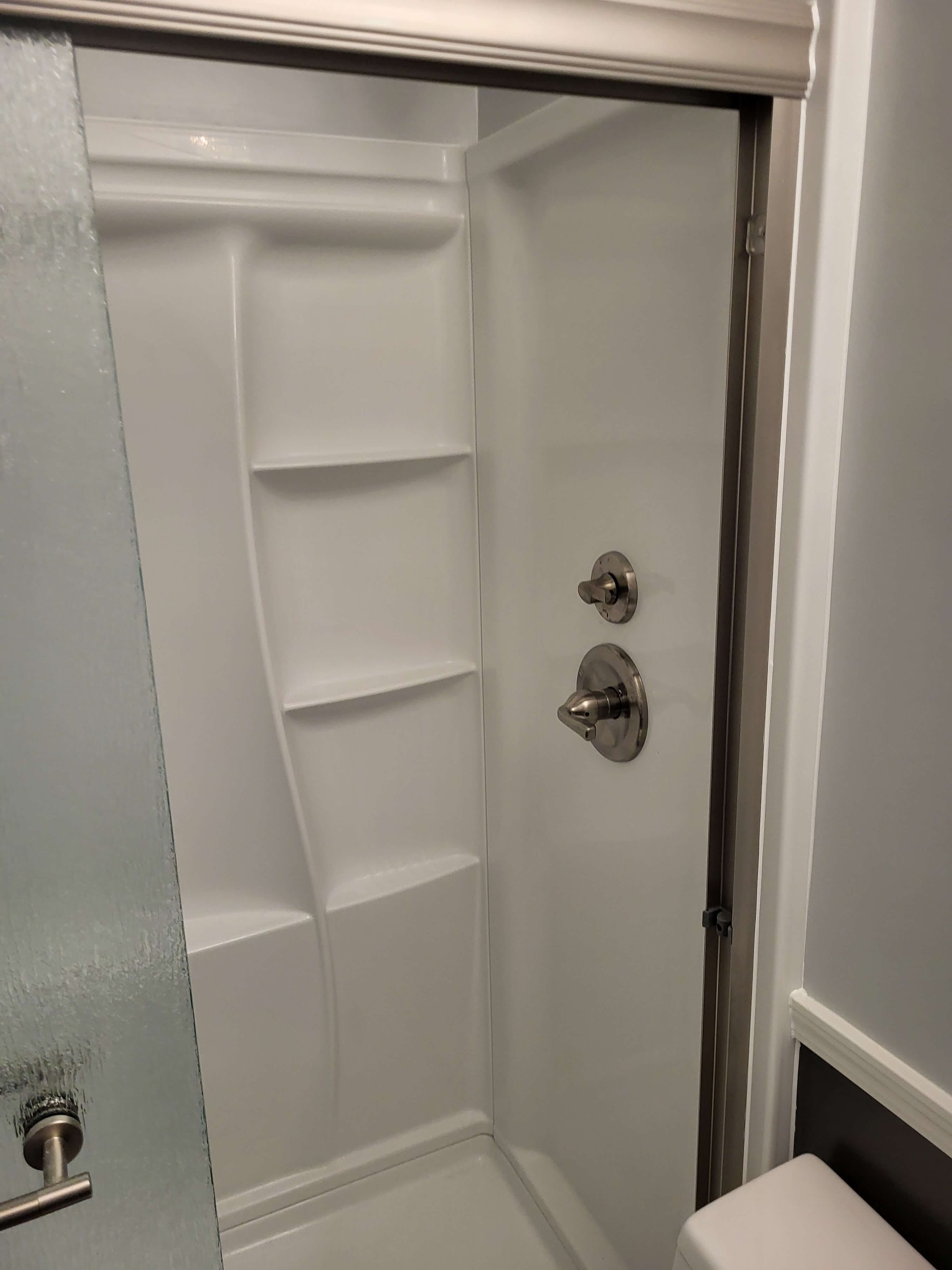 Shower Walls with Matching Fixtures and Clean Finish