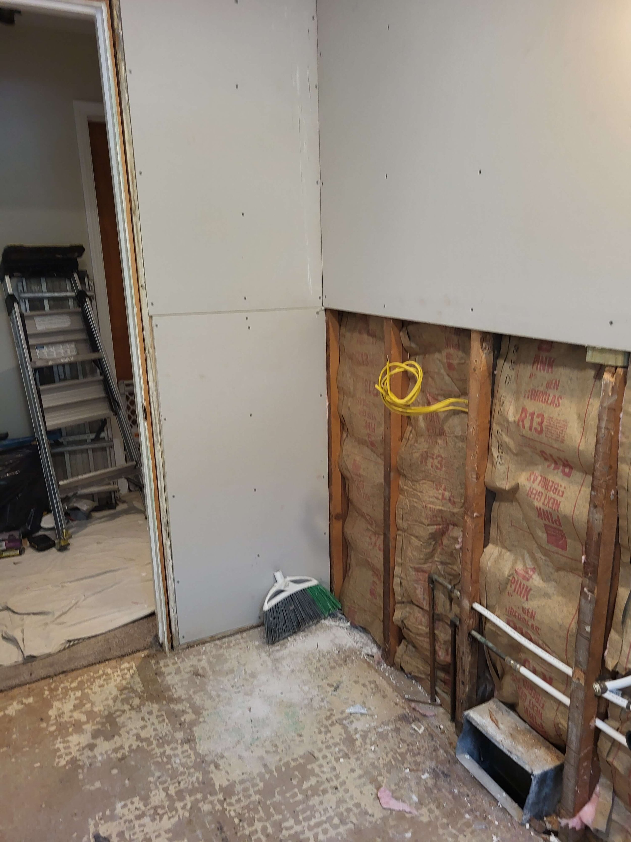 Installing moisture-resistant drywall and structural backing board during a local bathroom renovation project in Stow OH.