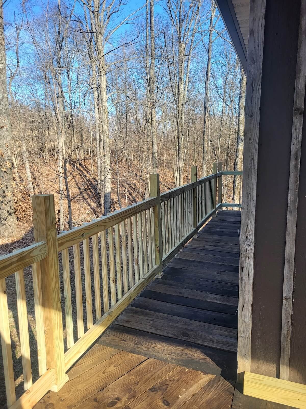 • Deep oil weatherproofing treated wood board decking finish dark cabin aesthetic.