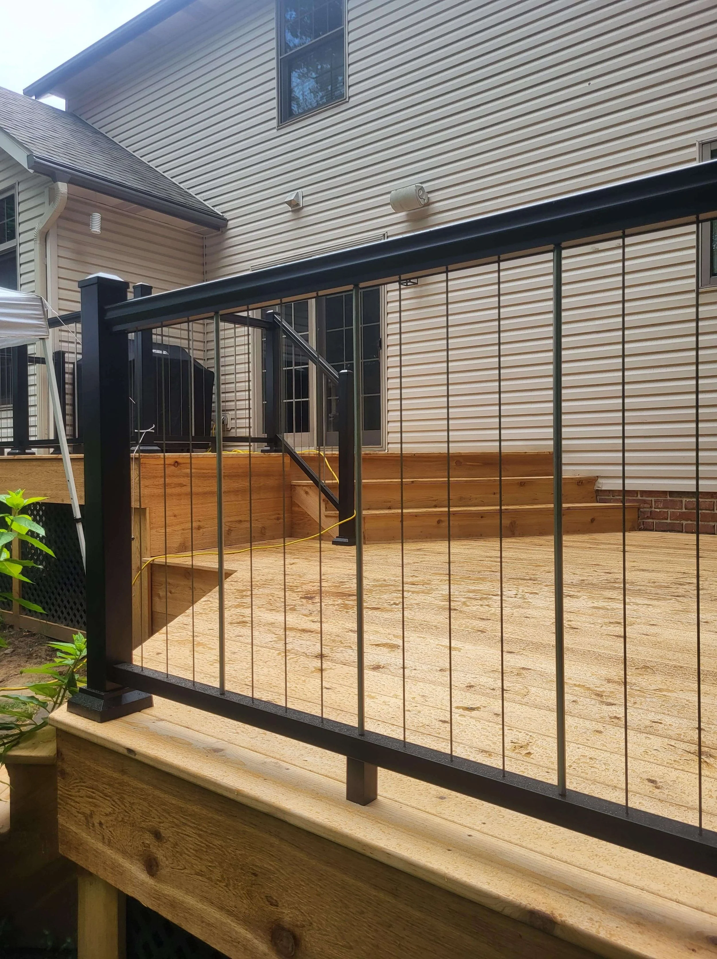 Close-up of custom vertical railing design on cedar deck showcasing modern style and craftsmanship