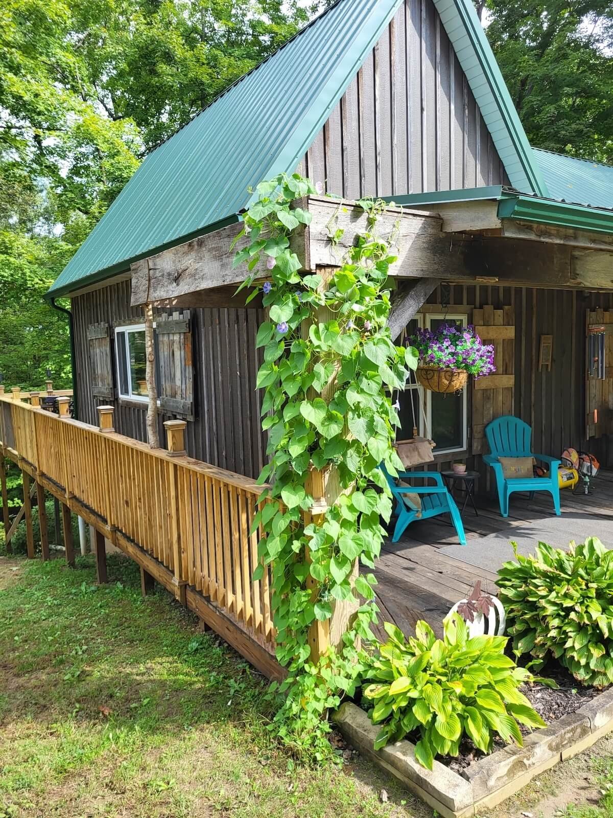 Custom side deck extension connecting front porch to rear deck on a rustic cabin.