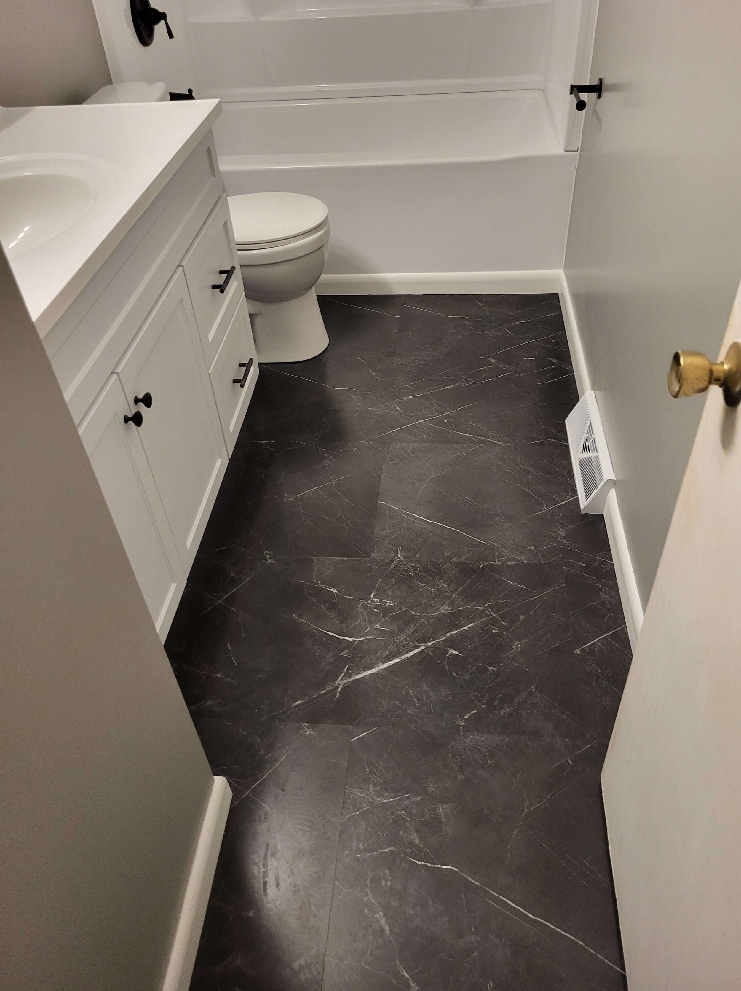 Dlr Construction bathroom renovation with a new toilet, shower, and LFT-Tile flooring installed. Located in Northeast, Ohio.