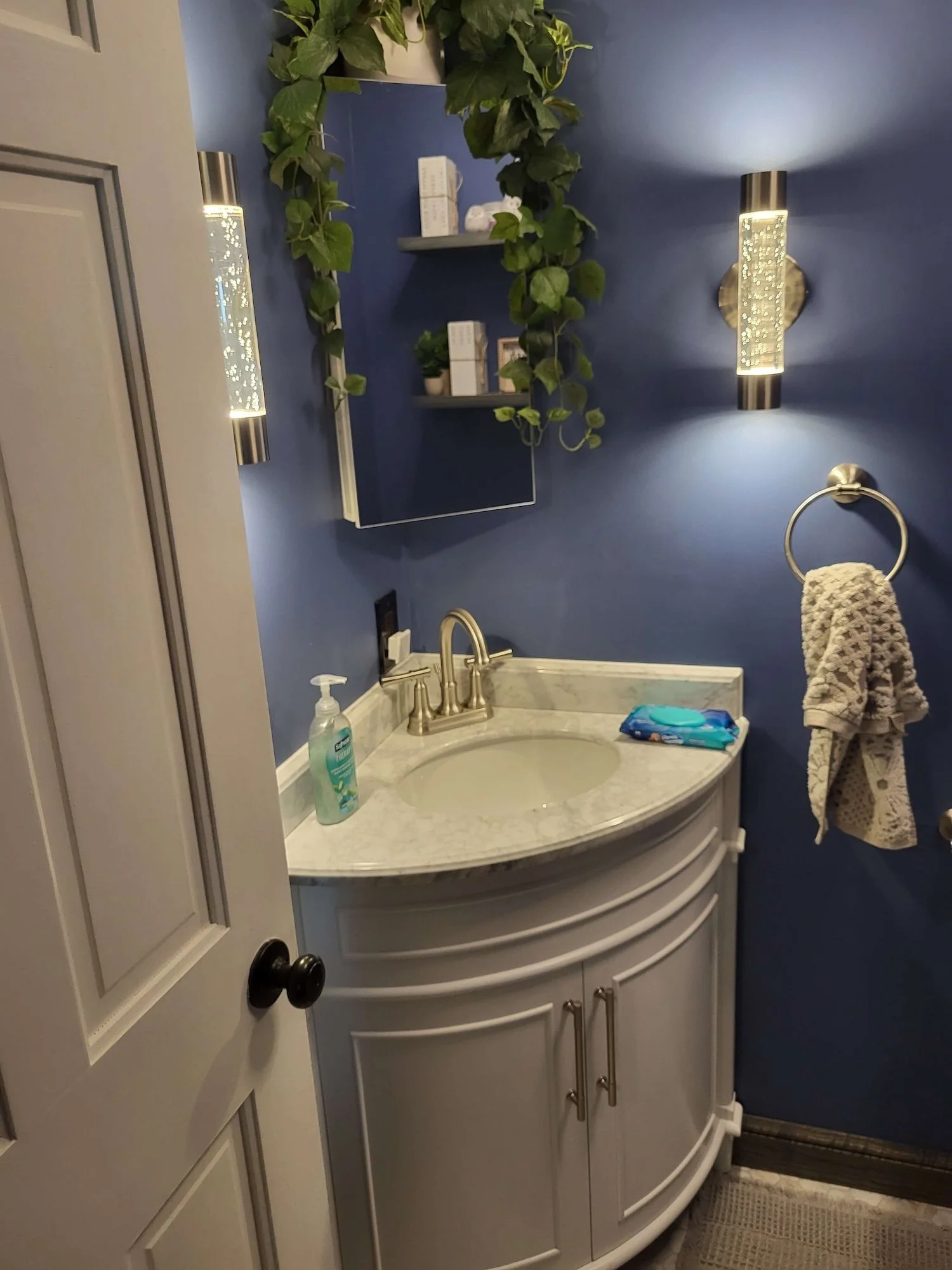 DLR Construction bathroom renovations in Cleveland Ohio showing a custom modern curved vanity and dual wall sconce lighting.