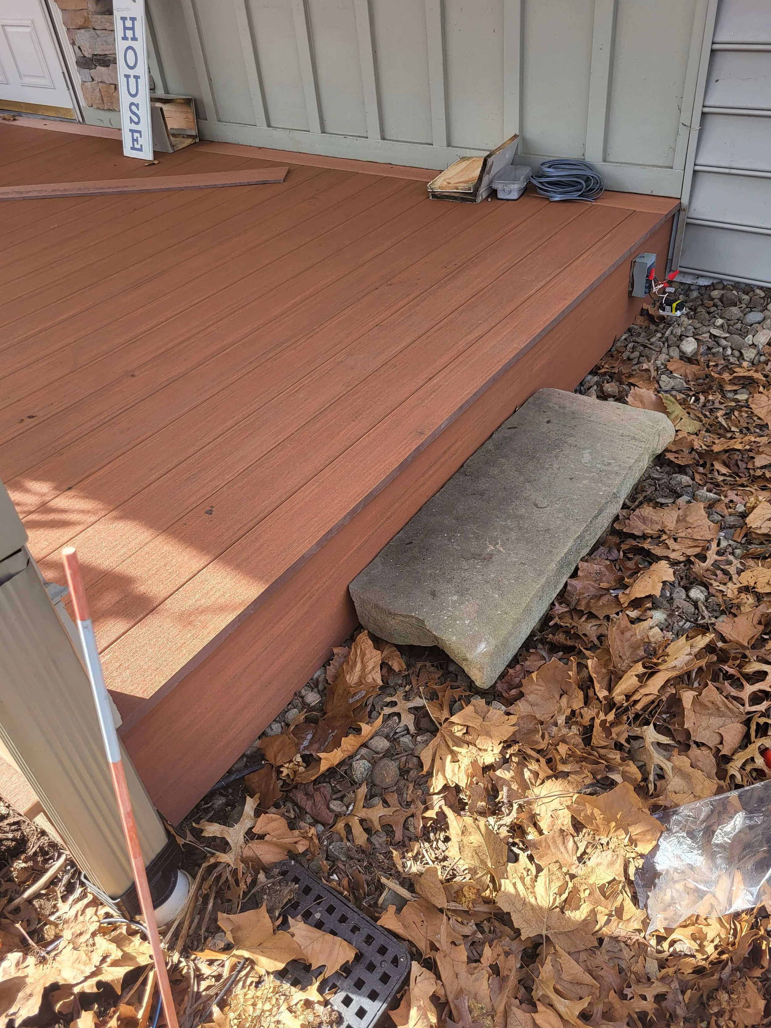 Front deck renovation with composite decking and electrical boxes added on both sides.
