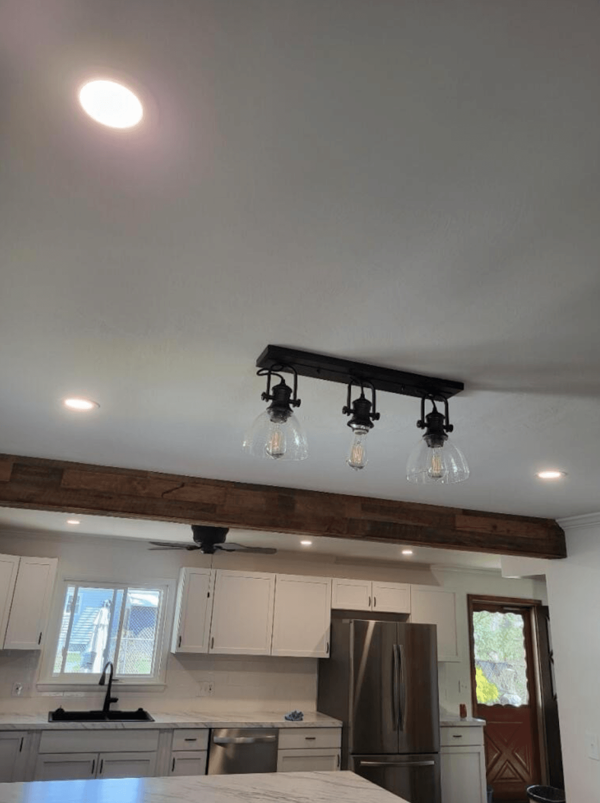 Modern recessed can lighting layout in an open concept kitchen renovation