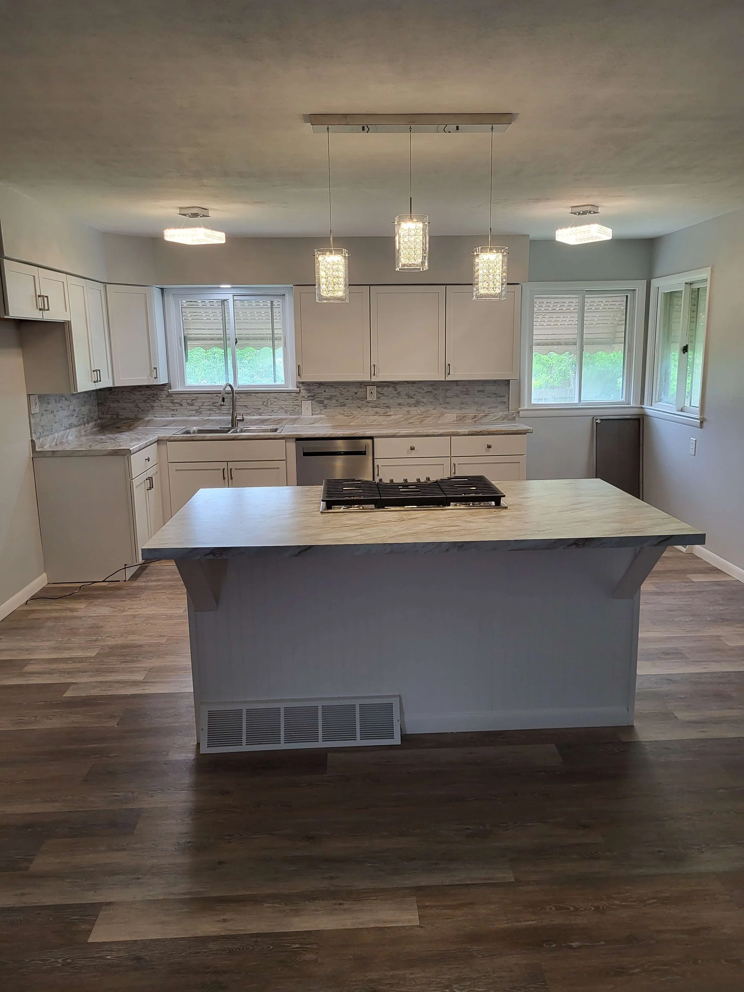 Completed custom kitchen remodel in Canton Ohio featuring updated cabinets, flooring, lighting, and open concept design