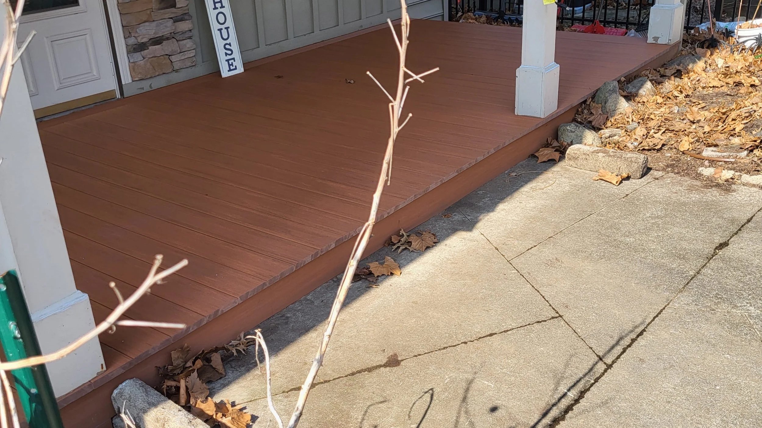 Front porch with composite decking and clad board improving curb appeal
