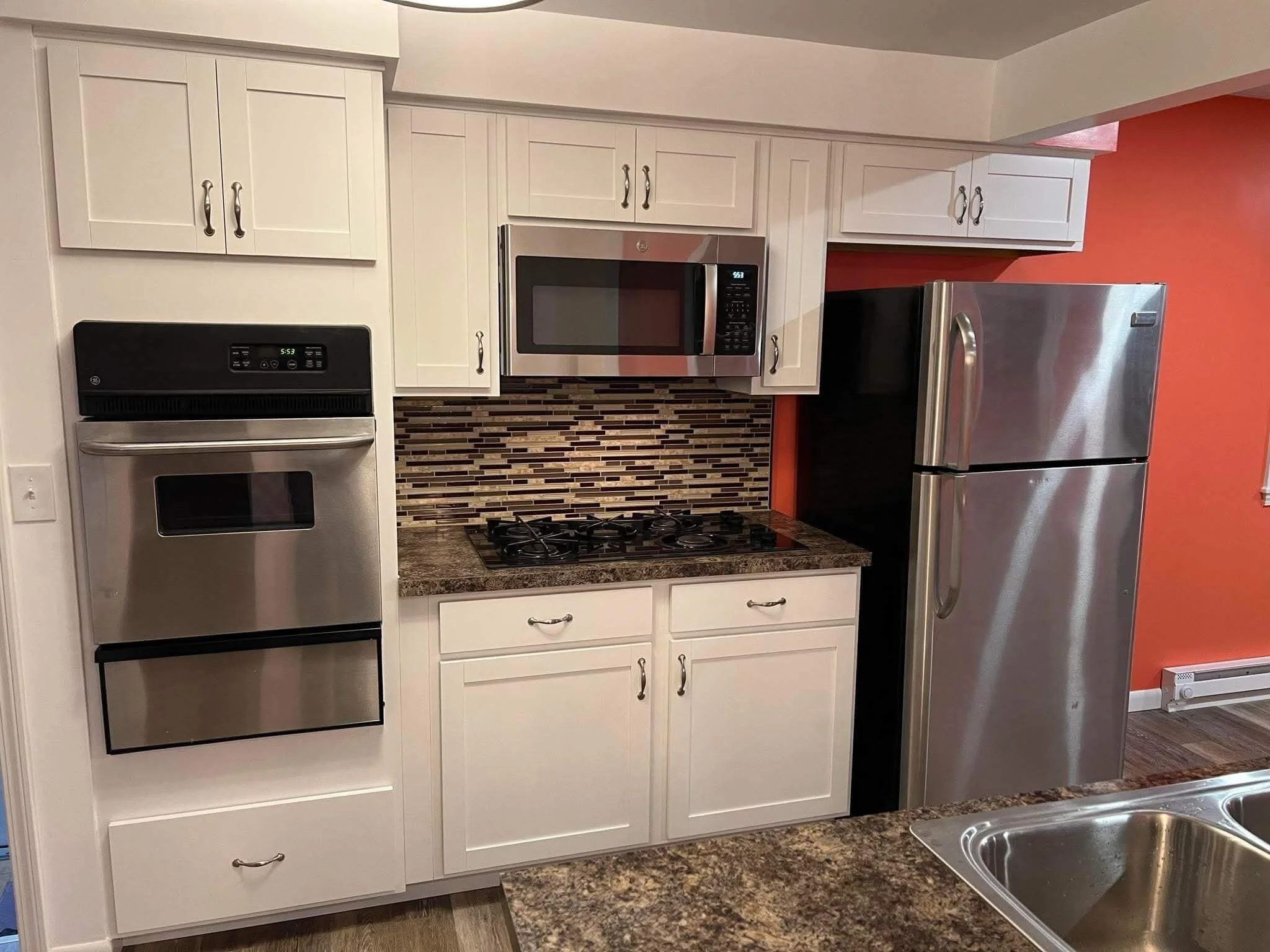 Custom kitchen cabinet layout with built-in wall oven completed during Kent Ohio kitchen renovation