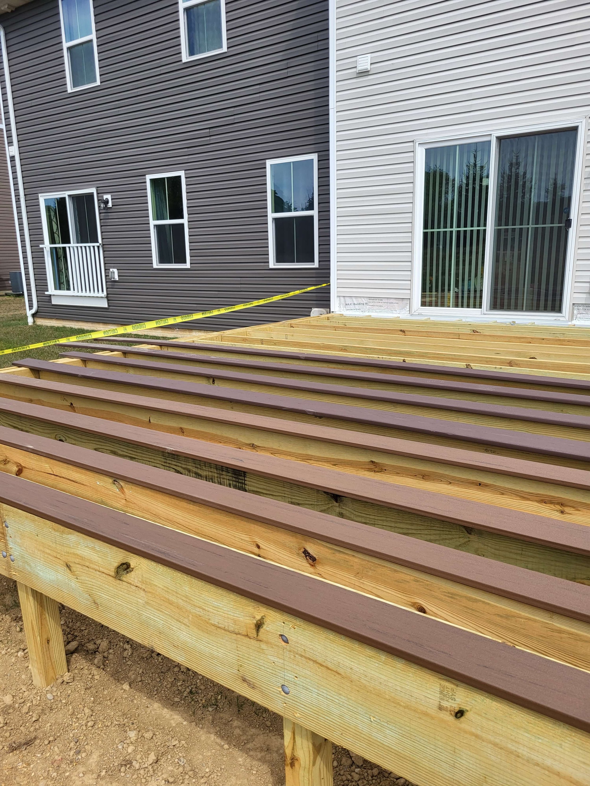 Pressure-treated wood framing for new deck construction showing joists and support layout