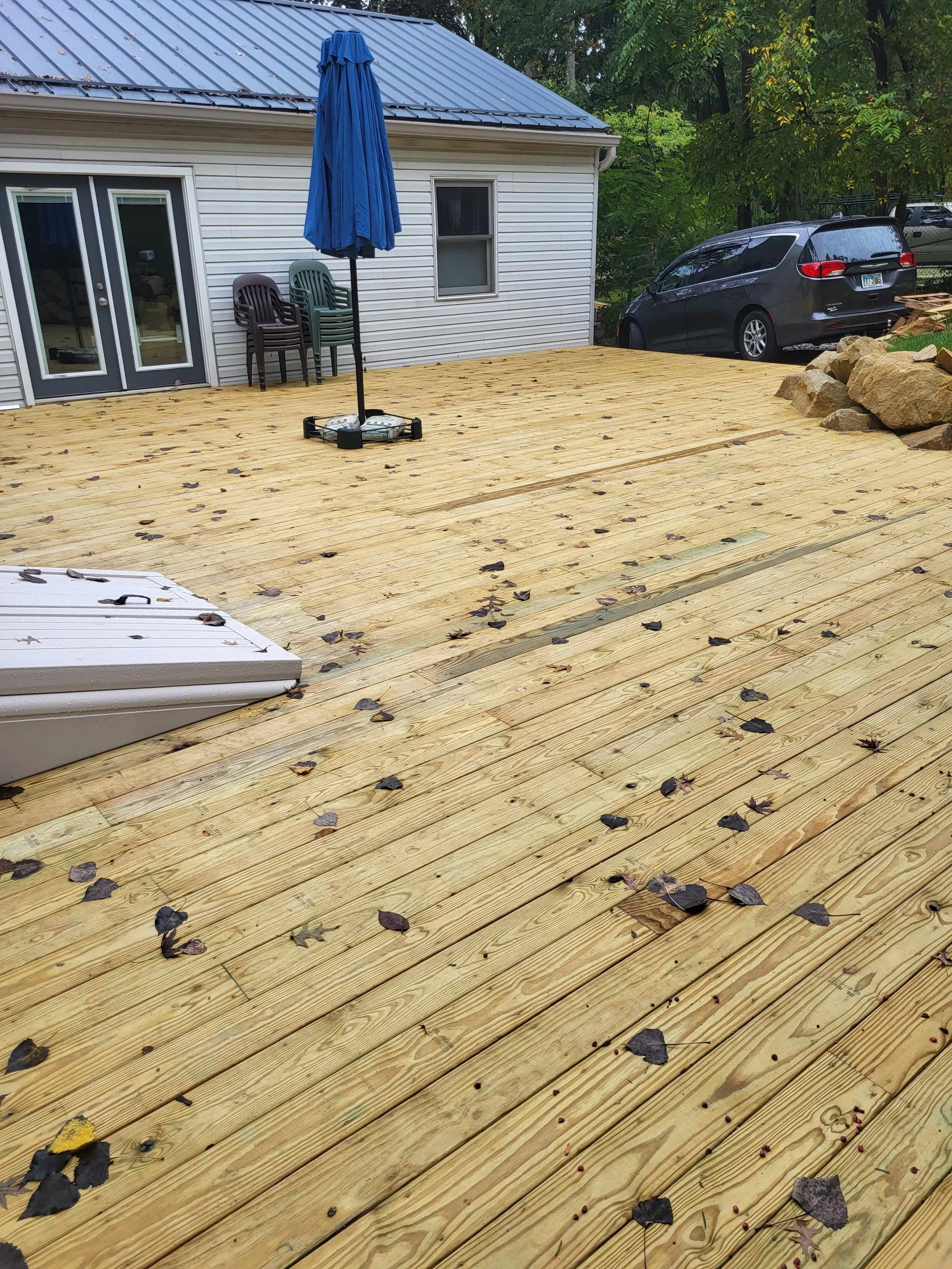 DLR Construction custom composite deck building in Northeast Ohio built from scratch and integrated with a natural rock wall