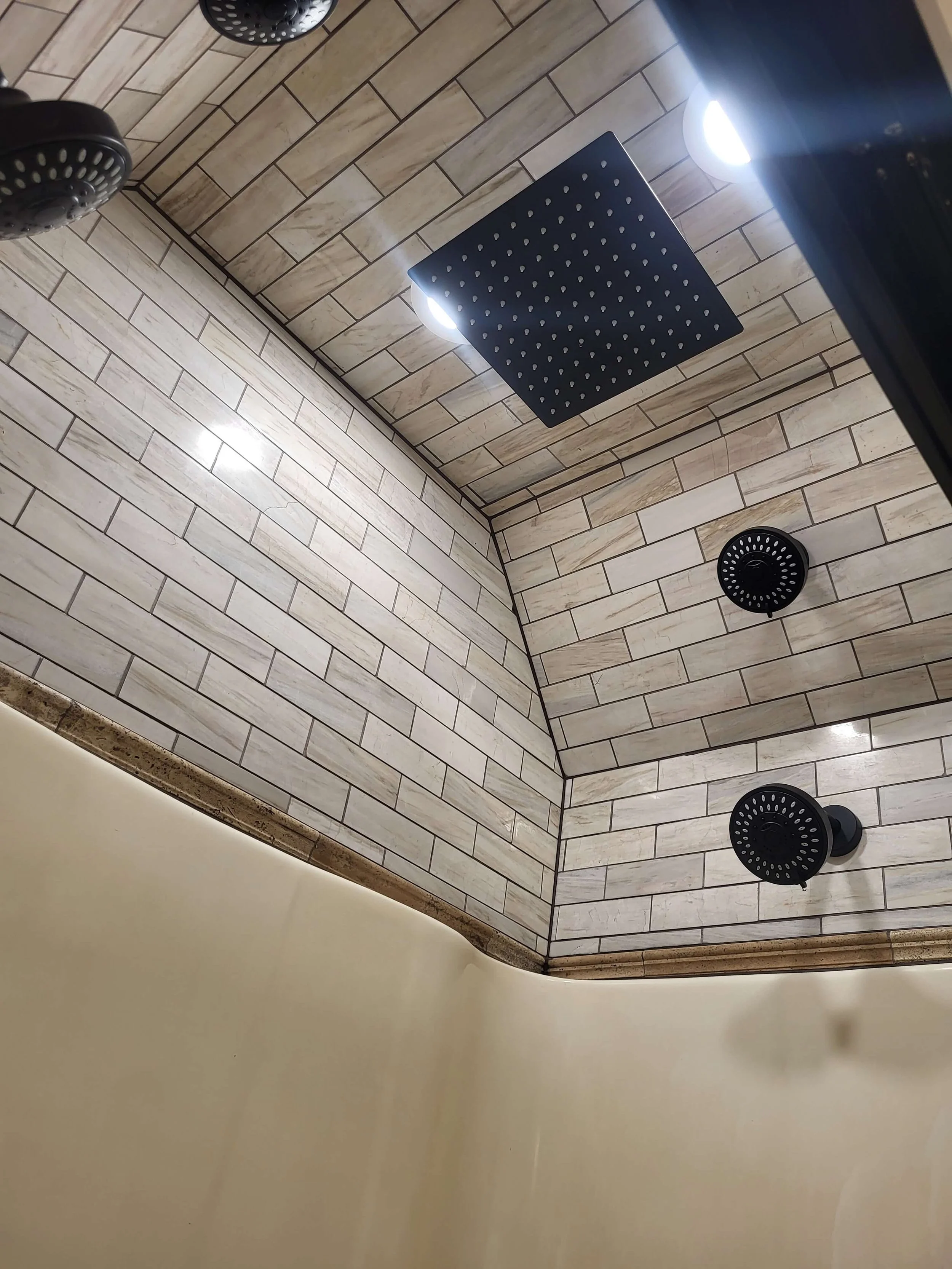 Sauna-style shower with wood ceiling and rainfall showerhead