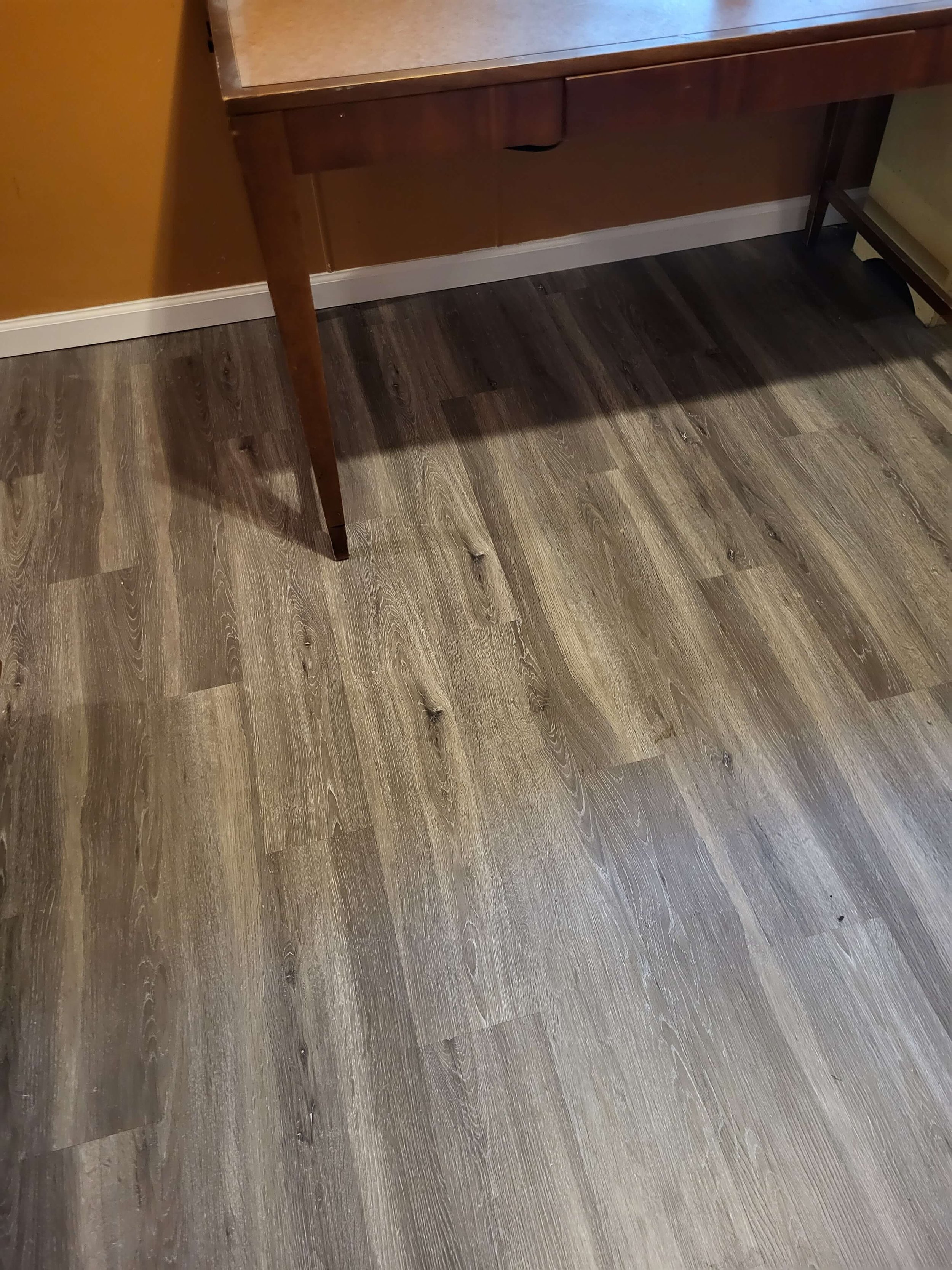 Premium luxury vinyl plank flooring and baseboard trim installation by DLR Construction in Hudson, Ohio.