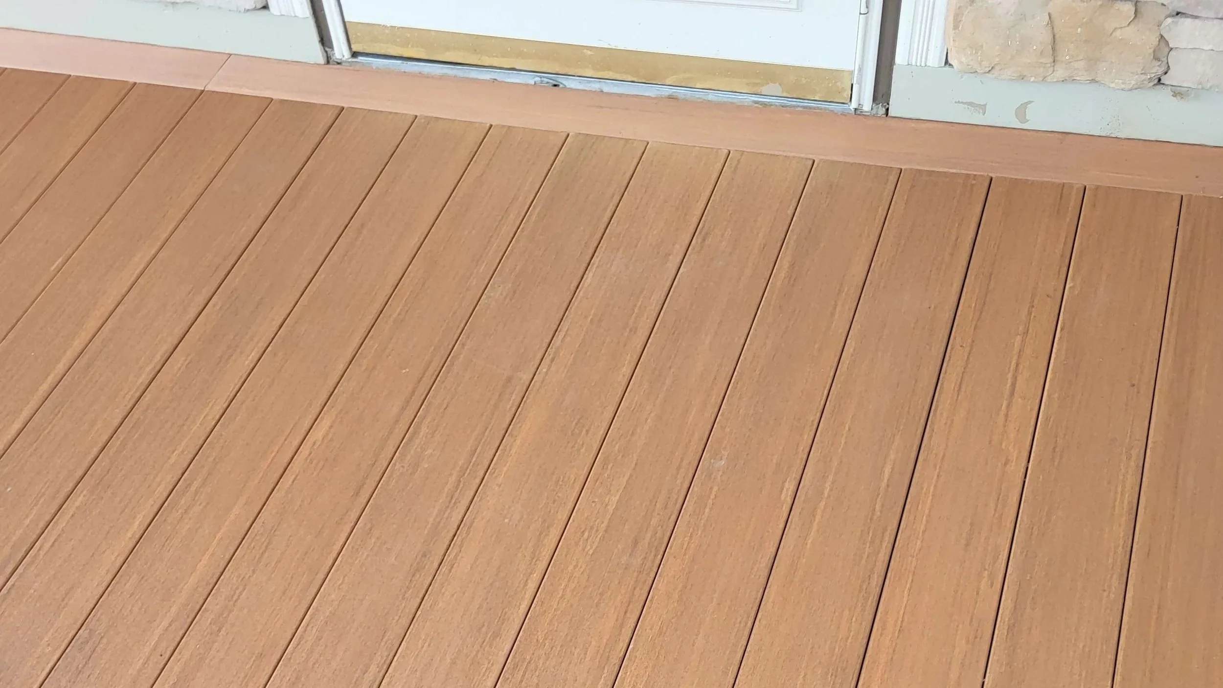 Composite decking perimeter board with clean finished edge detail