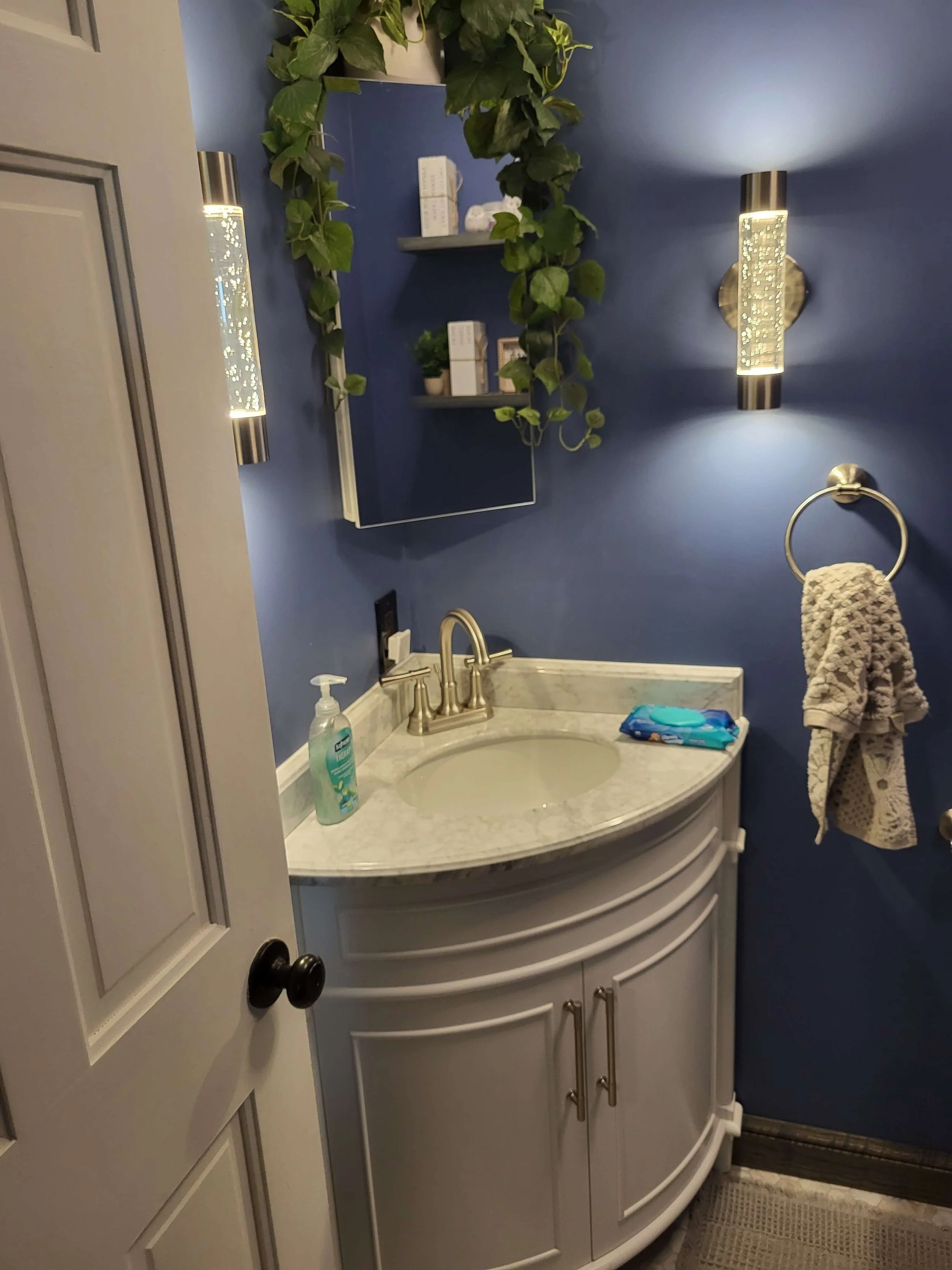 Half bathroom renovation in Northeast Ohio with custom corner vanity and updated plumbing