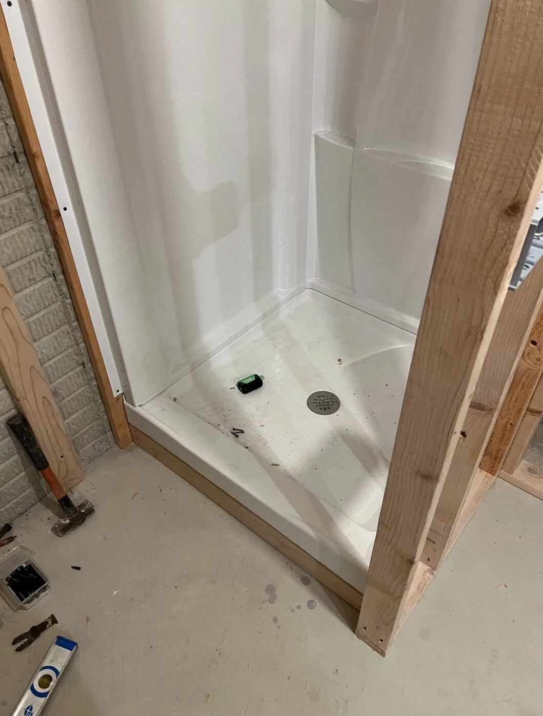 Basement shower pan installation with upflush plumbing system framework by DLR Construction