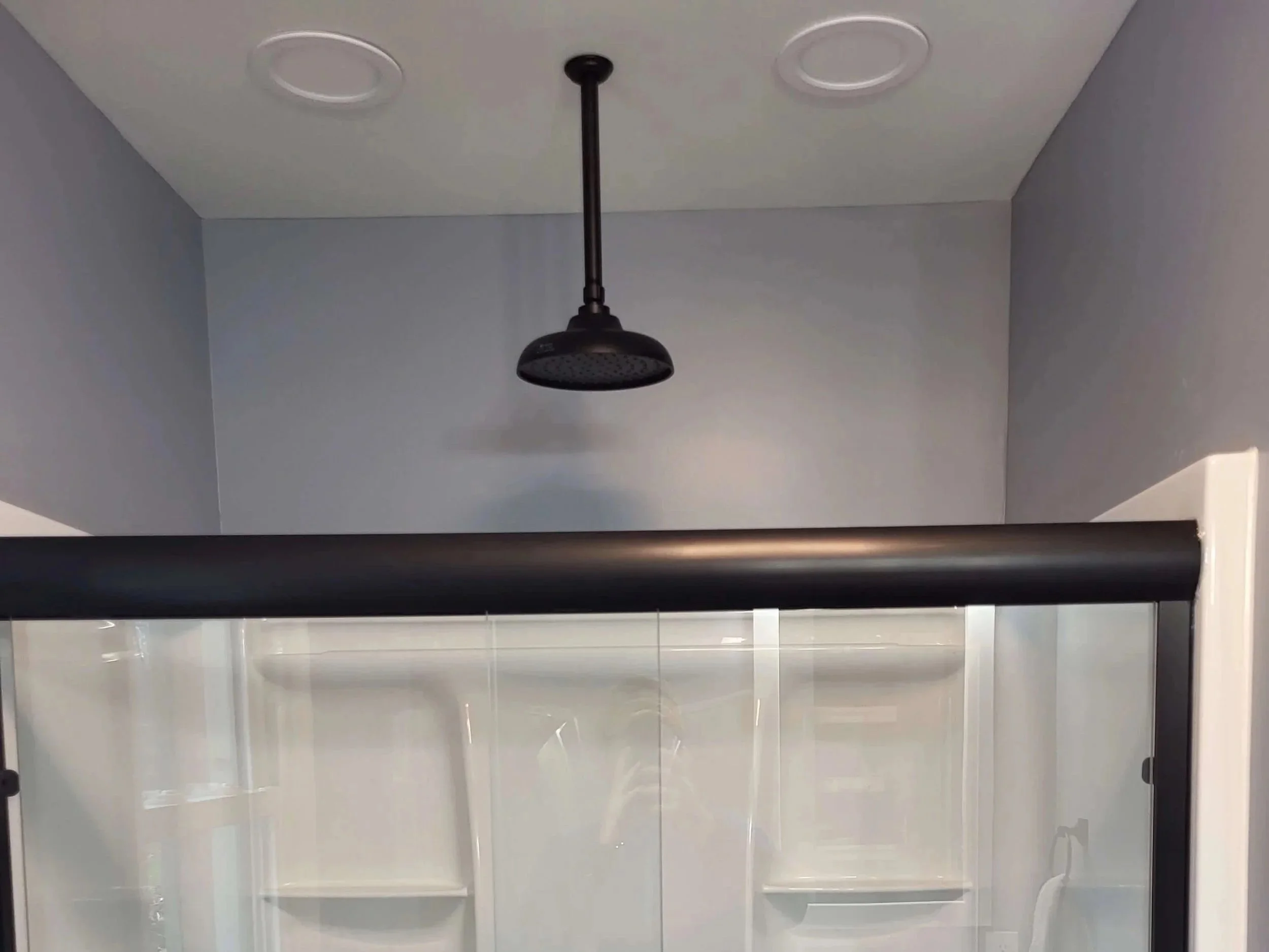 DLR Construction full bathroom renovation down to the studs with white vanity black fixtures and custom glass shower in Akron Ohio